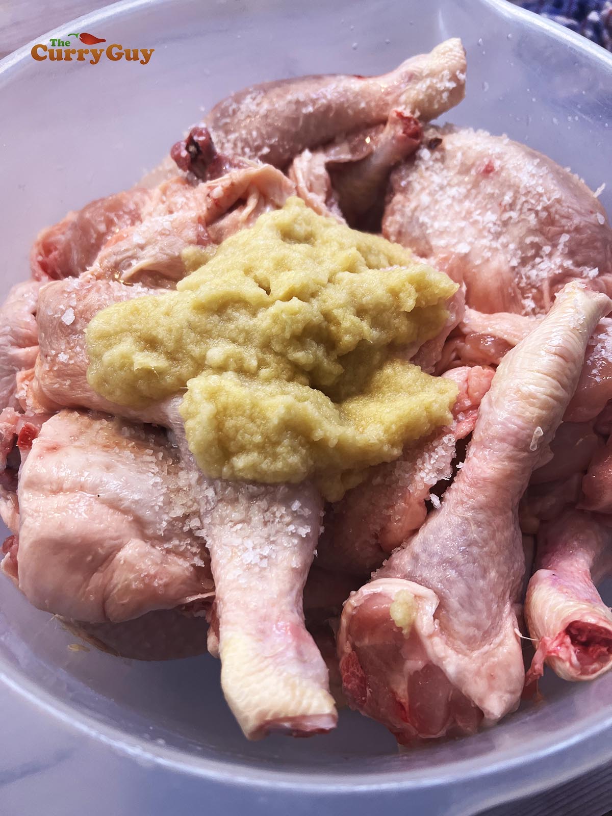 Adding first marinade to the chicken