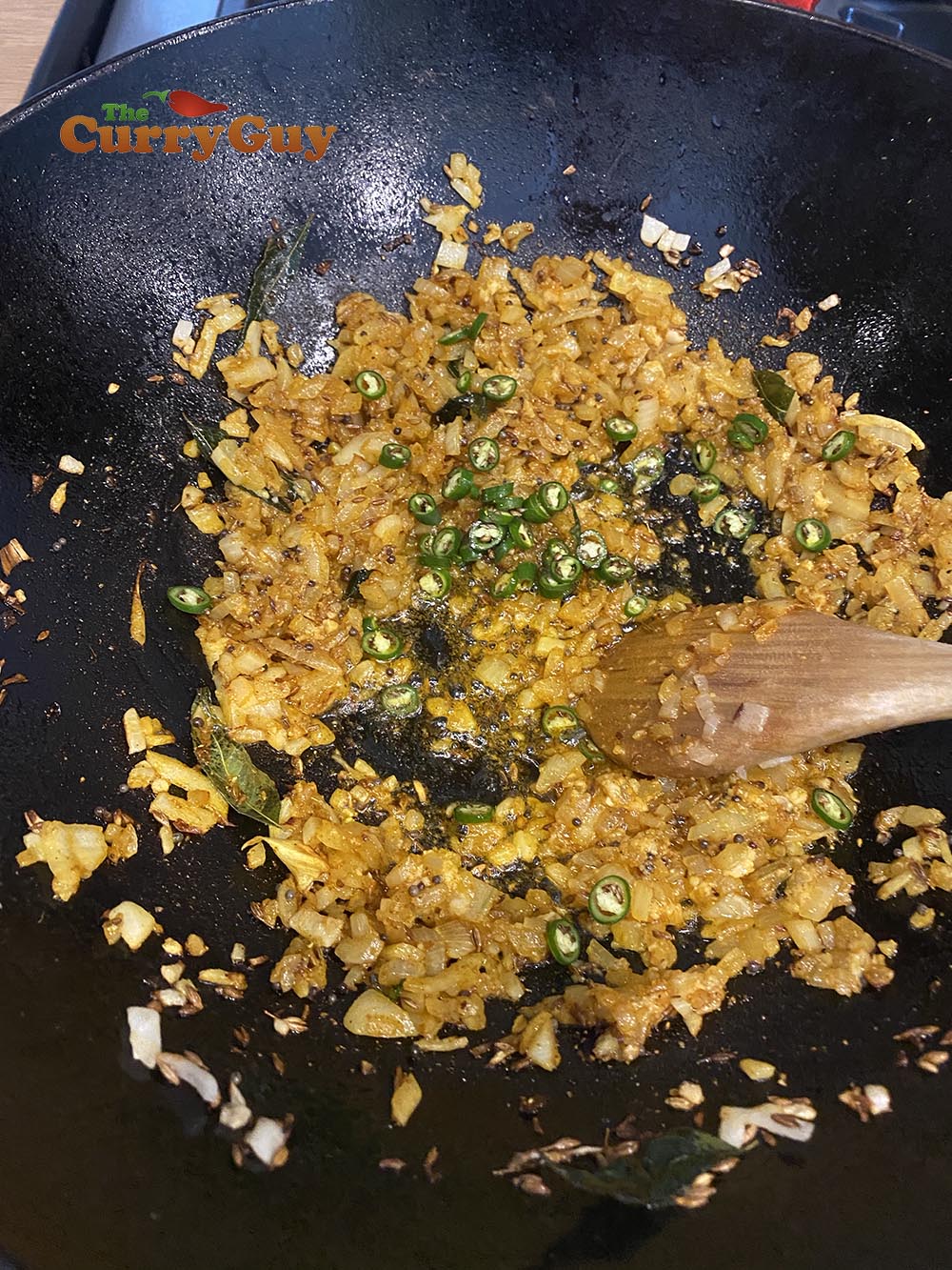 Stirring the chillies into the sauce