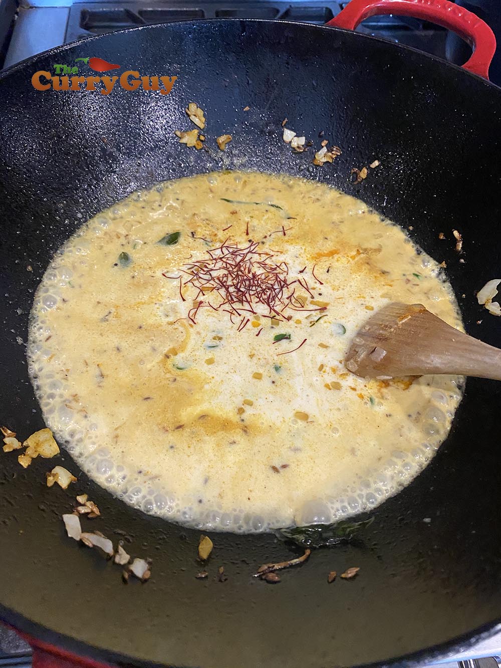 Adding coconut milk to the sauce