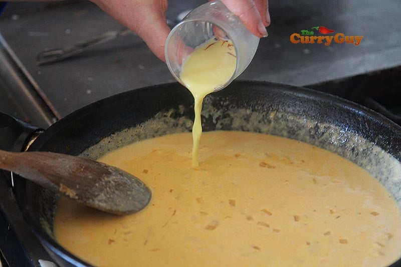 adding saffron milk to sauce