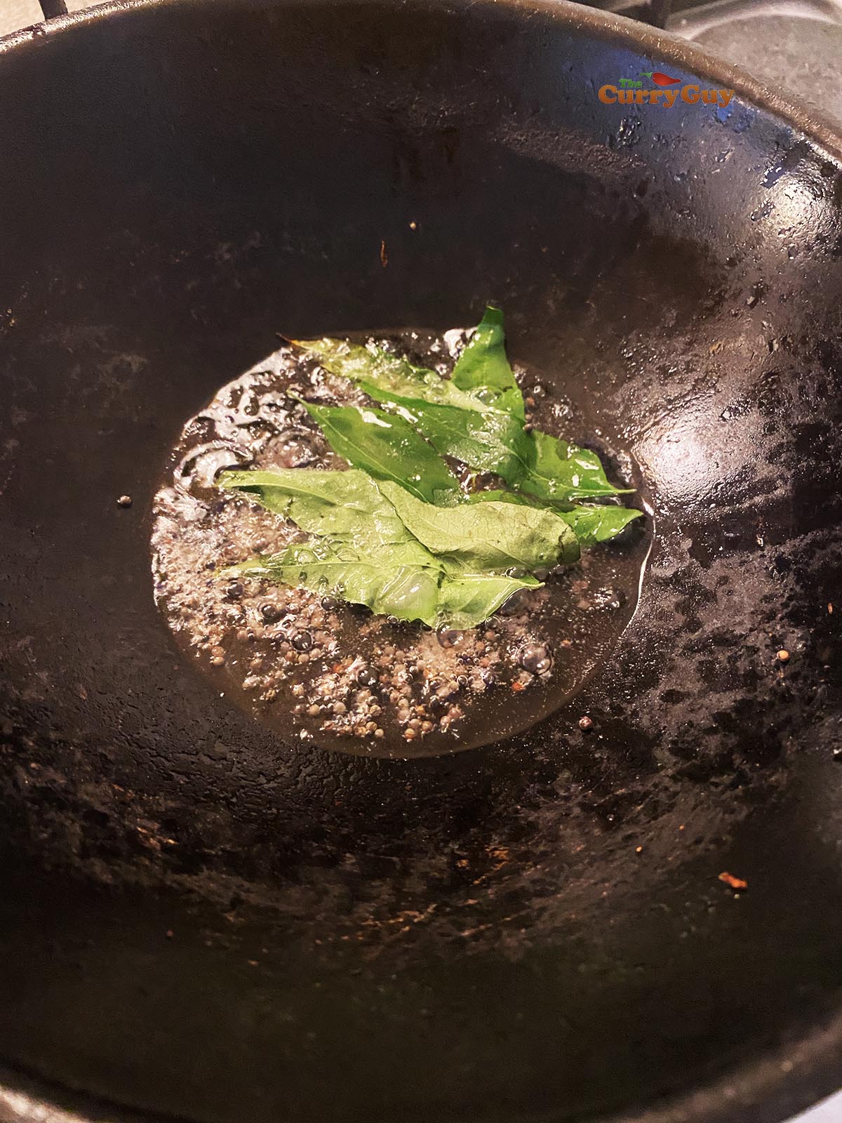 Frying mustard seeds and curry leaves