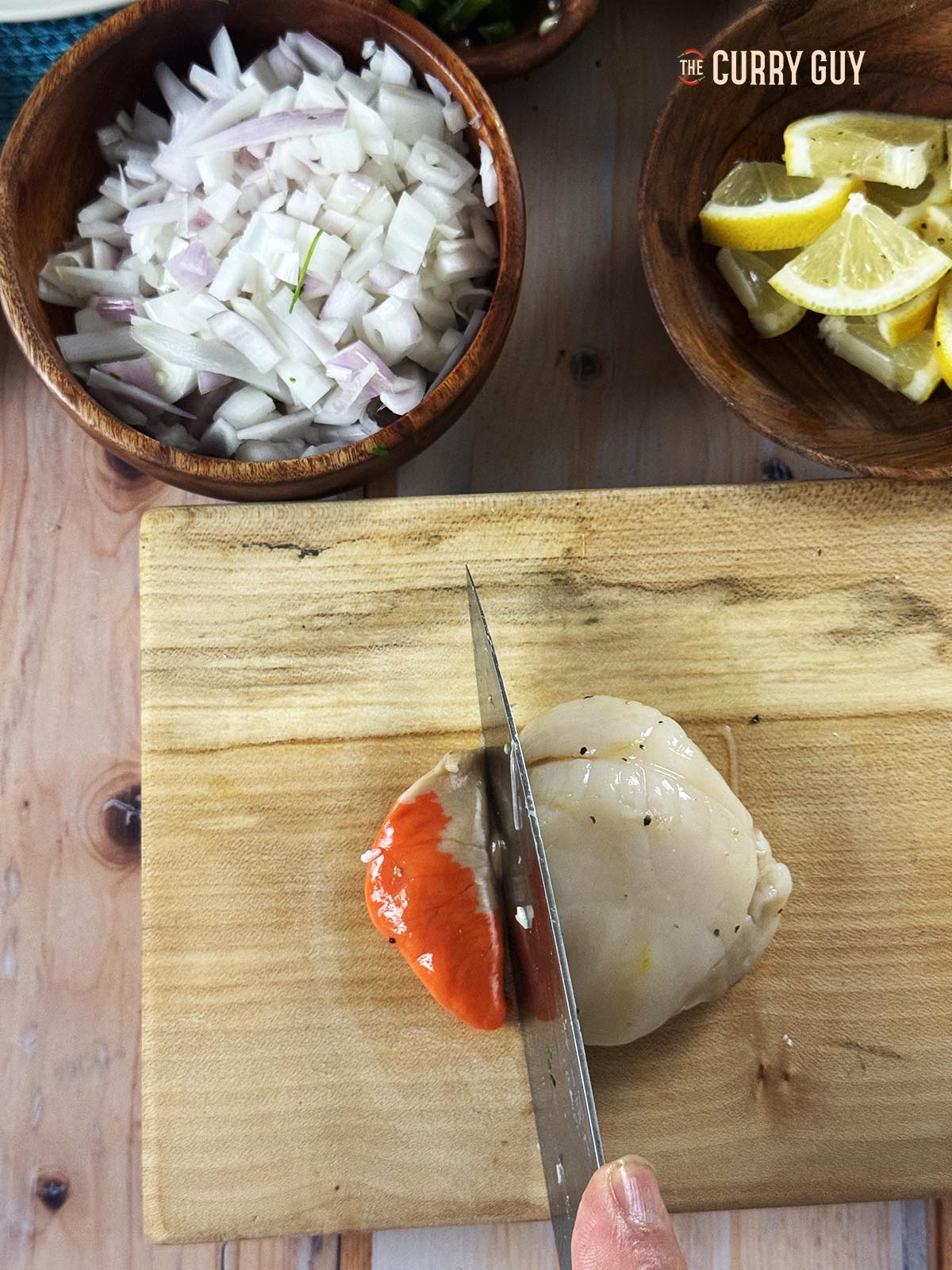 Cutting the roe off of the scallops.