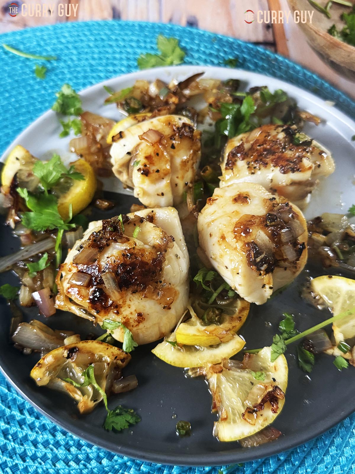 Pan seared scallops with fried shallots, chillies, garlic, lemon and coriander.