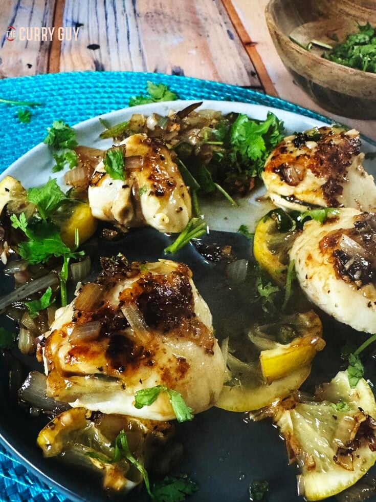 pan seared scallops on a serving plate with the sauce.