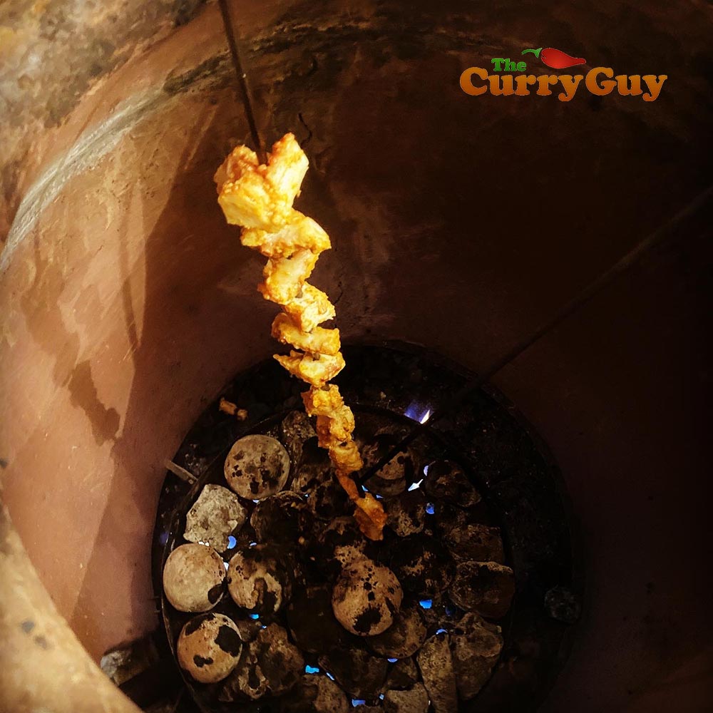 tandoori octopus cooking in tandoor oven