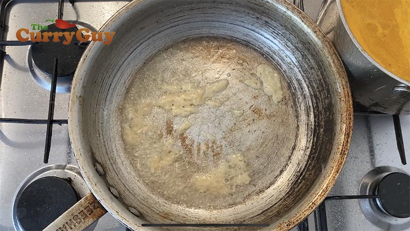 Adding oil and garlic to the pan