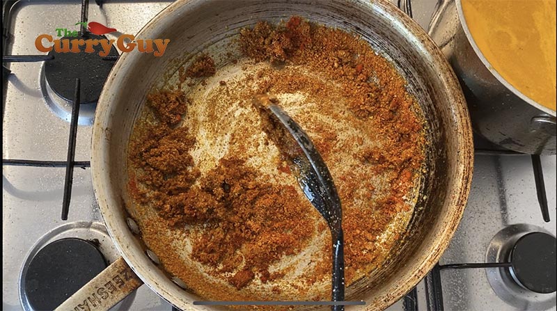 cooking spices into the chicken tikka masala sauce