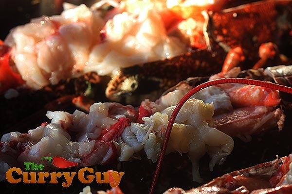 Pouring tandoori sauce over lobster