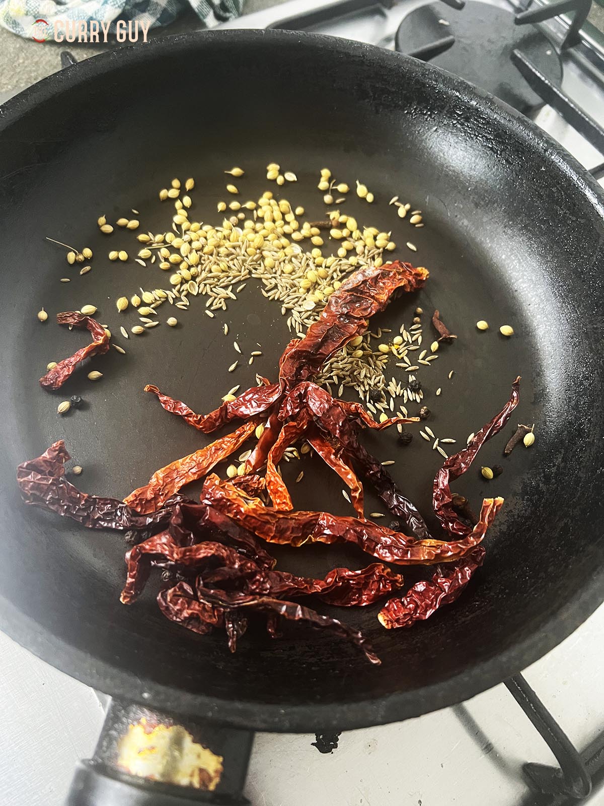 Toasting the whole spices in a pan. 