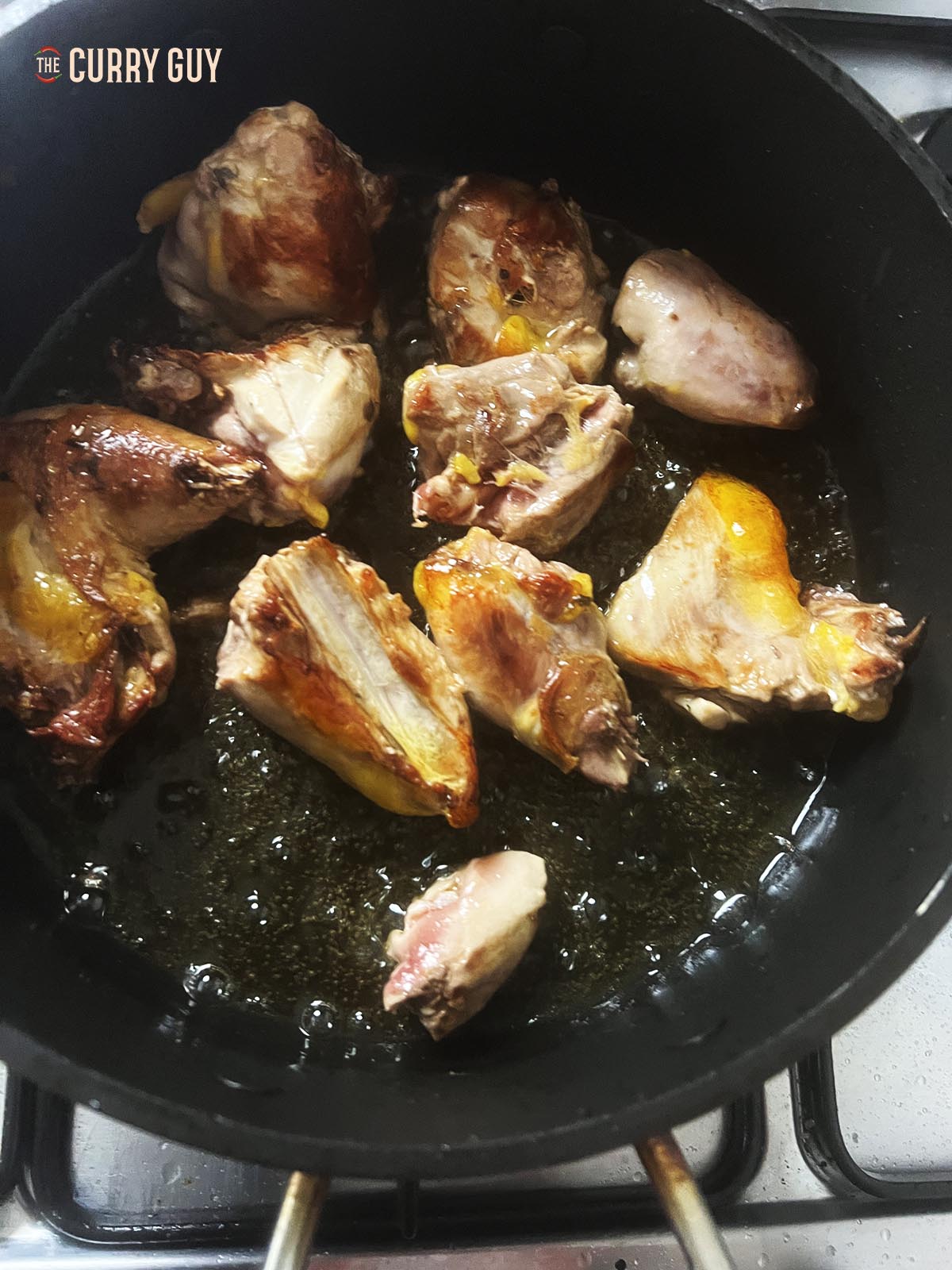Browning the pheasant in oil in a pan.