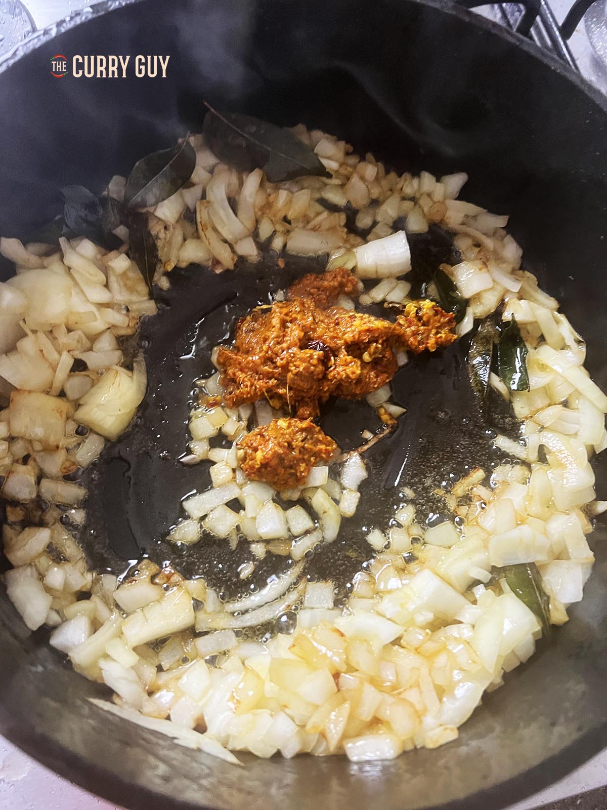 Adding the prepared spice paste to the pan.