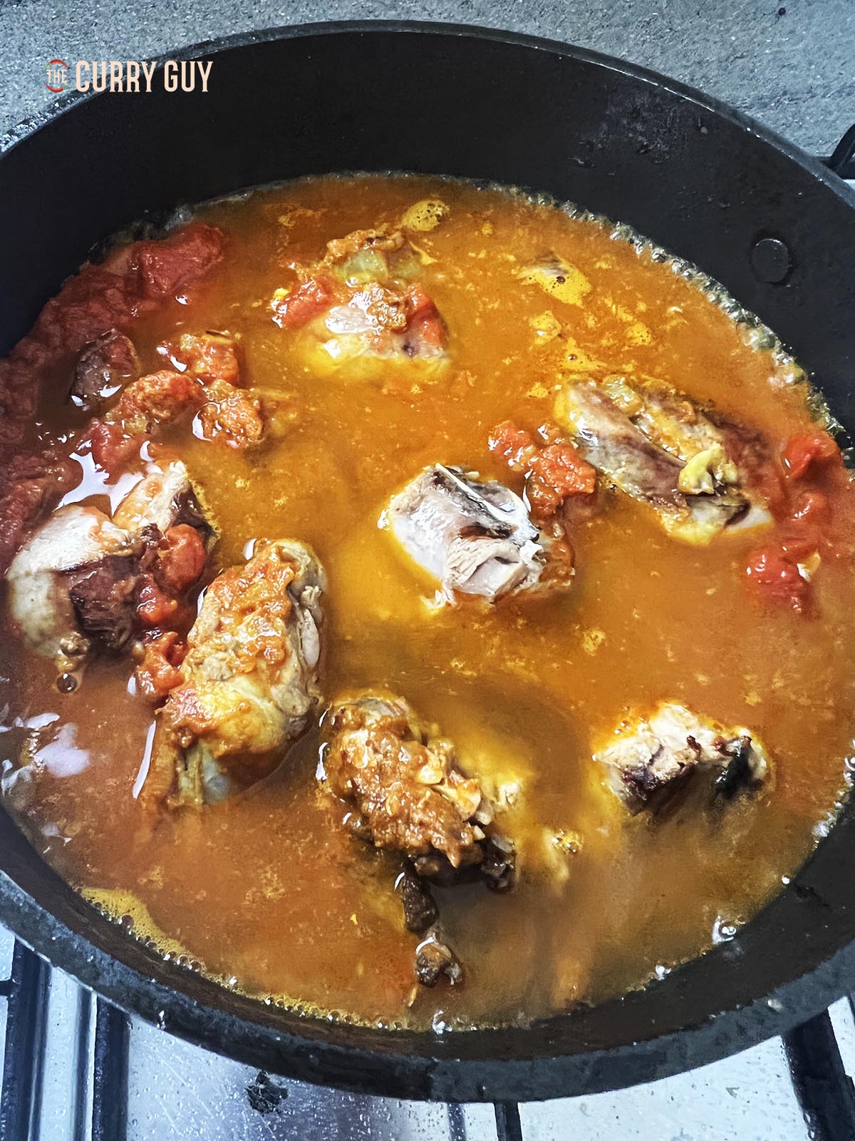 Adding chicken stock to the pan.