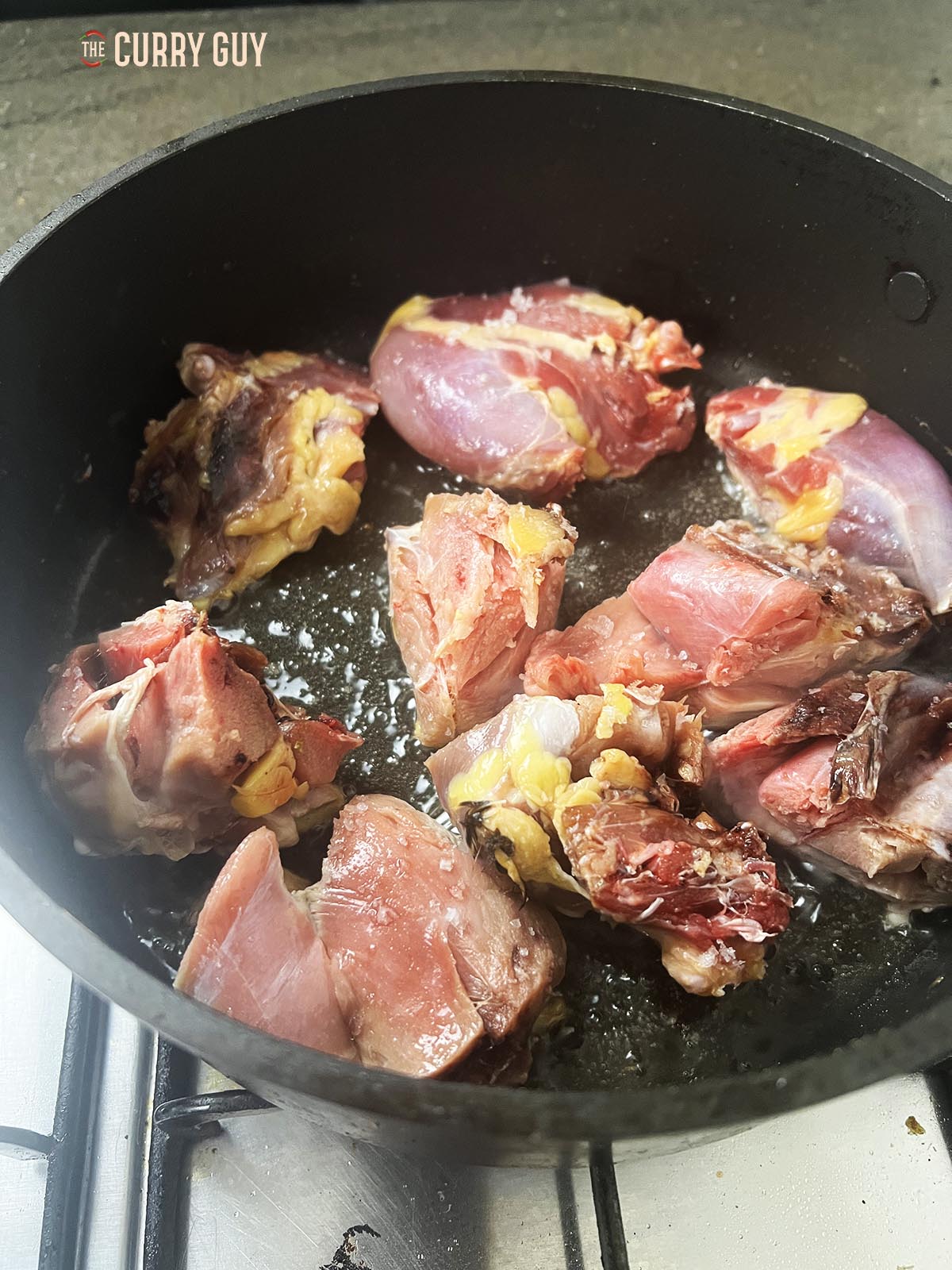 Adding the pheasant pieces to a hot pan with oil.