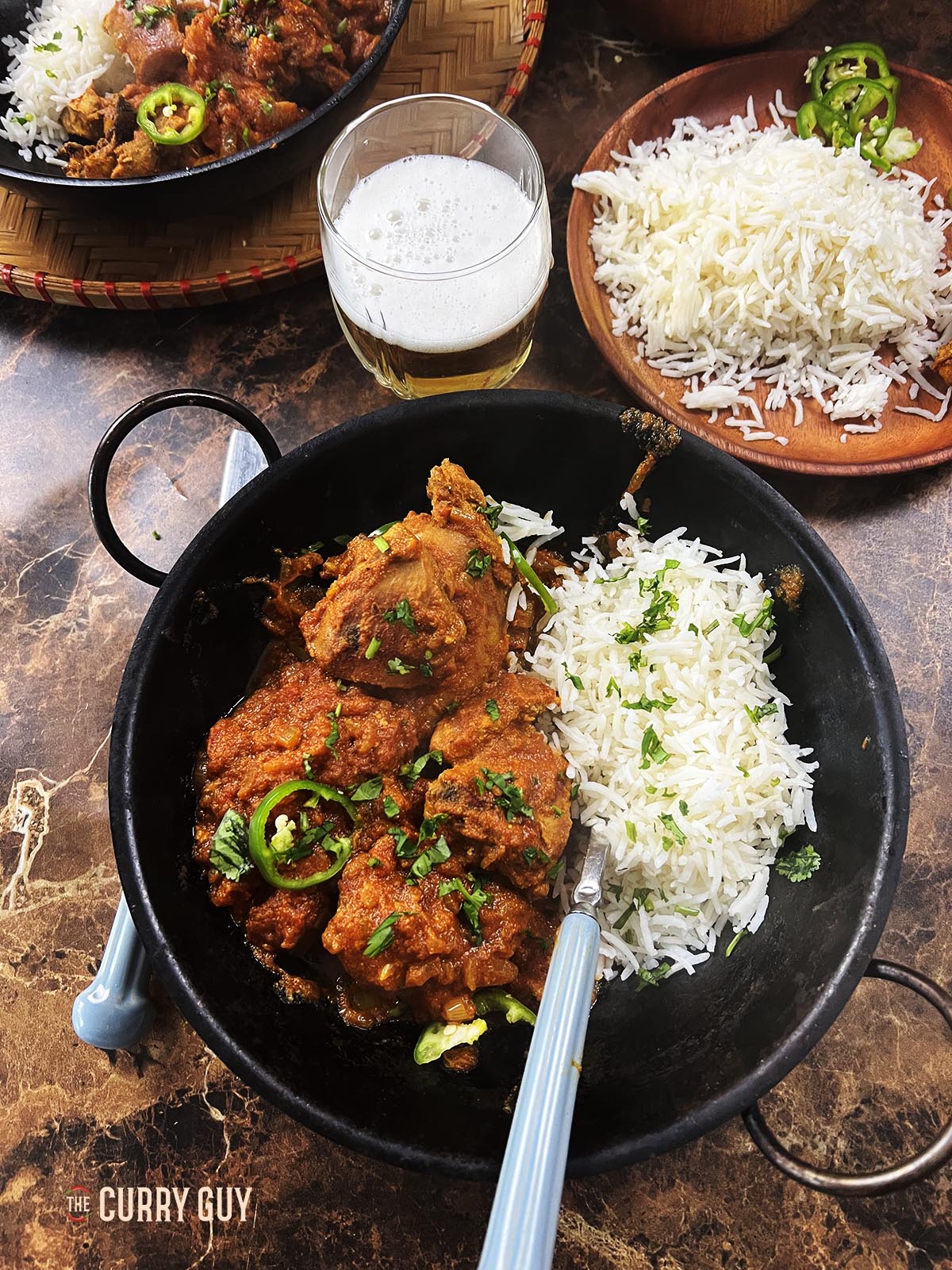 Spicy pheasant curry served with rice at the table. 