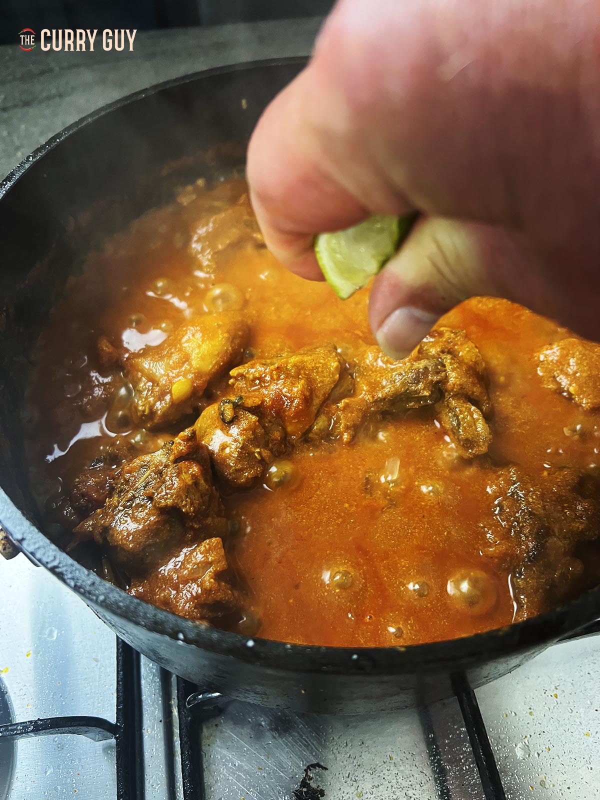 Adding lime juice to the curry.