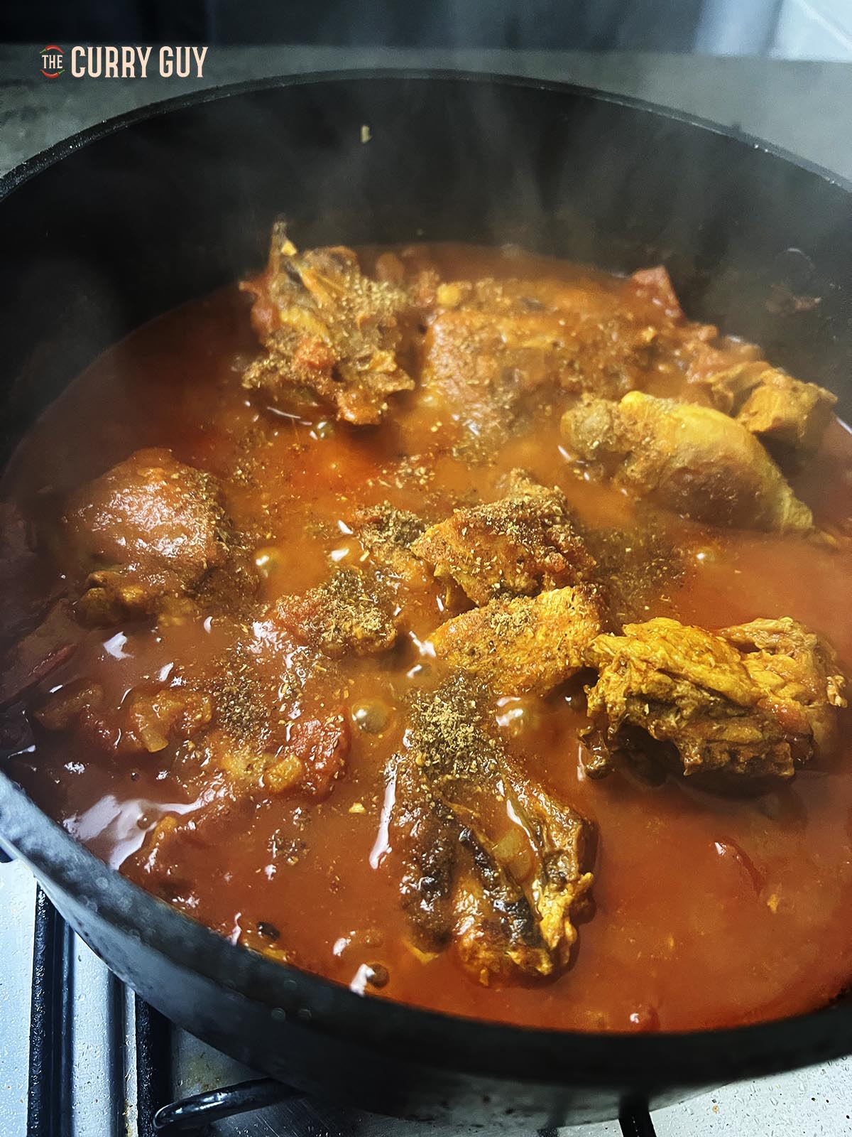 Adding yogurt to the curry.