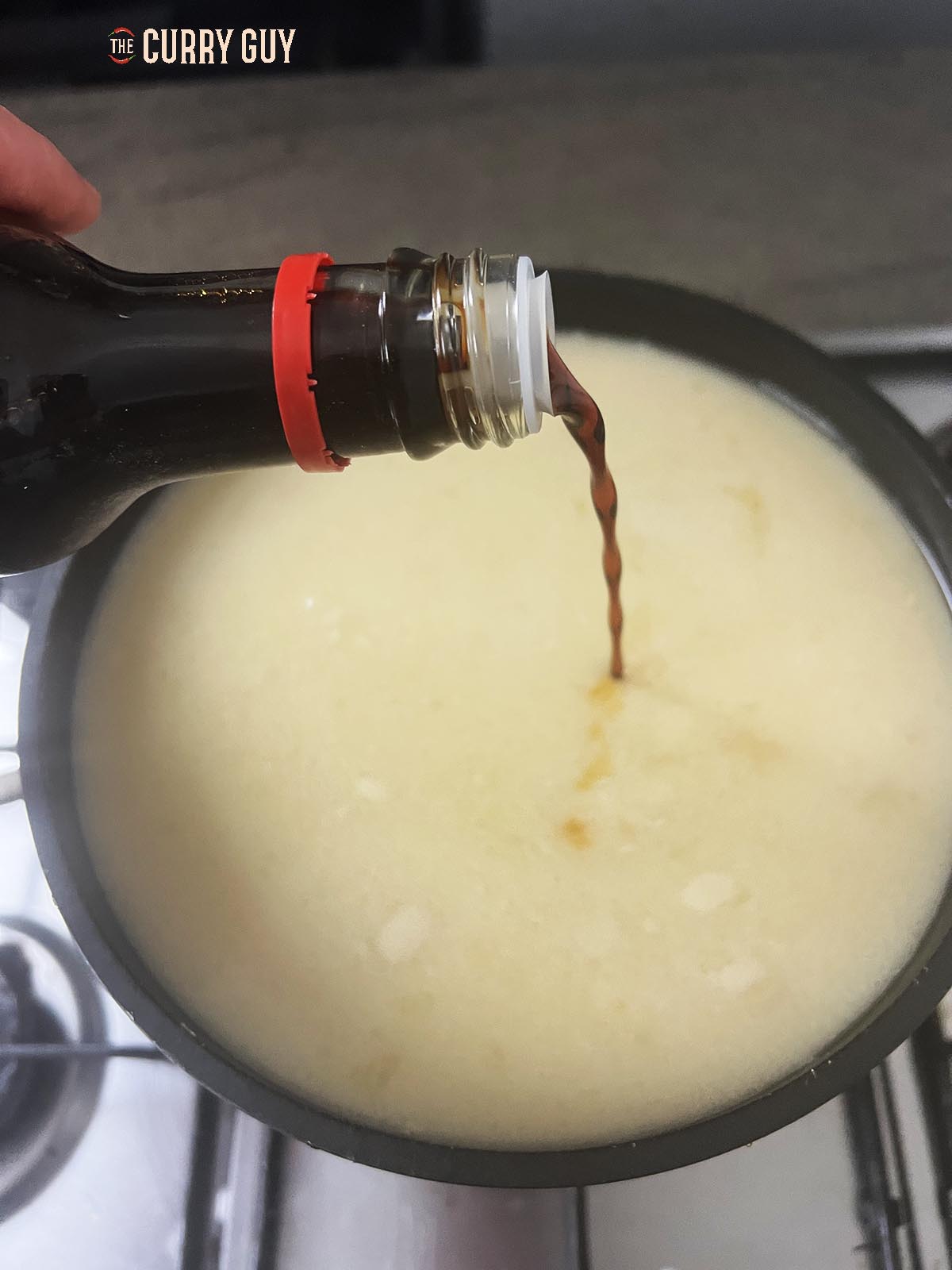 Pouring soy sauce into tonkotsu ramen broth
