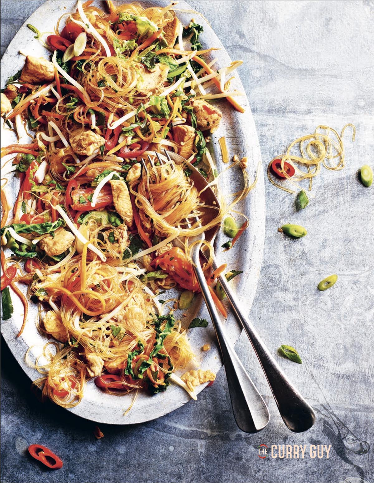 Chicken with Glass noodles stir fry on a serving plate.