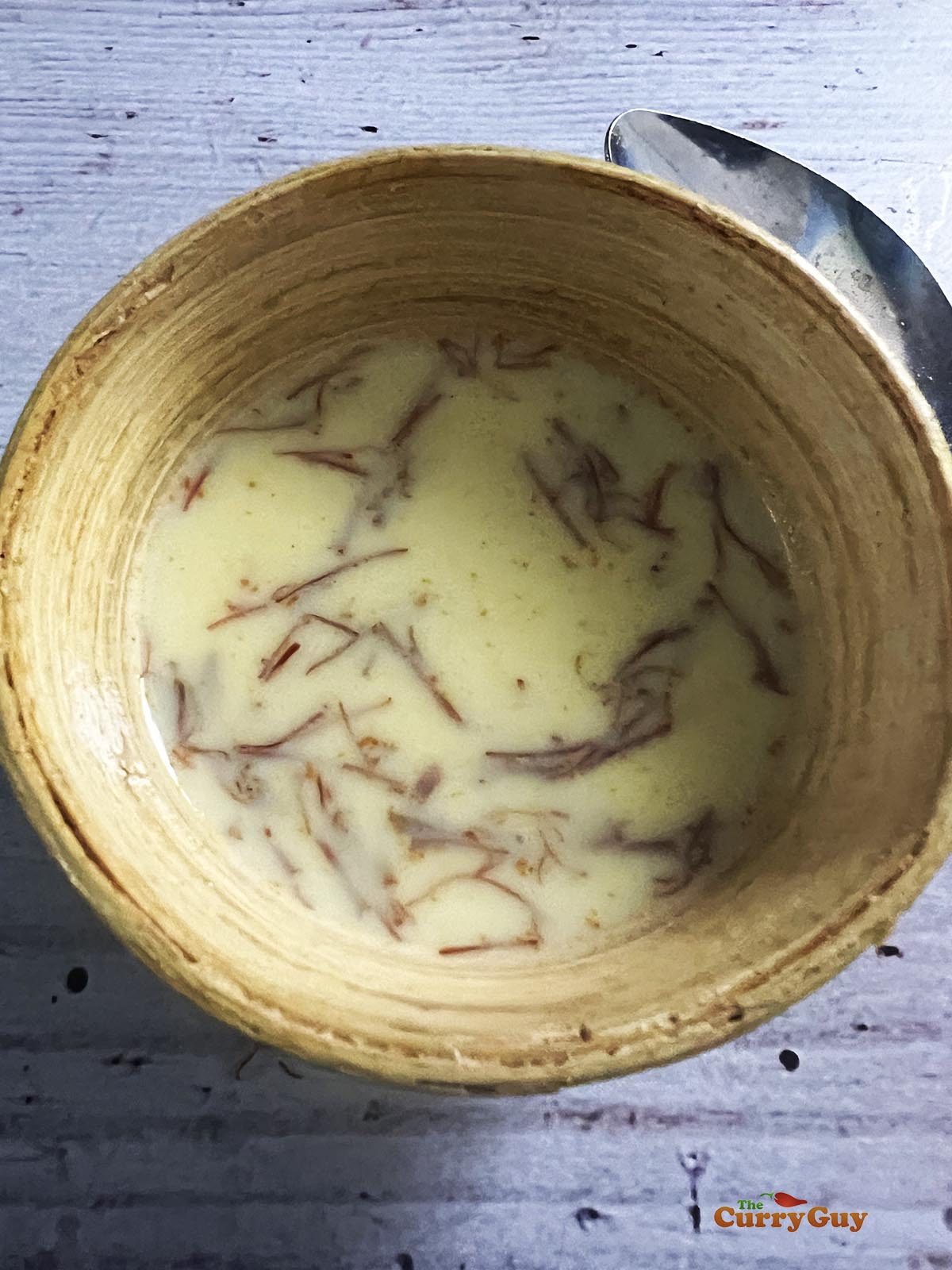 Saffron infusing into the hot milk.