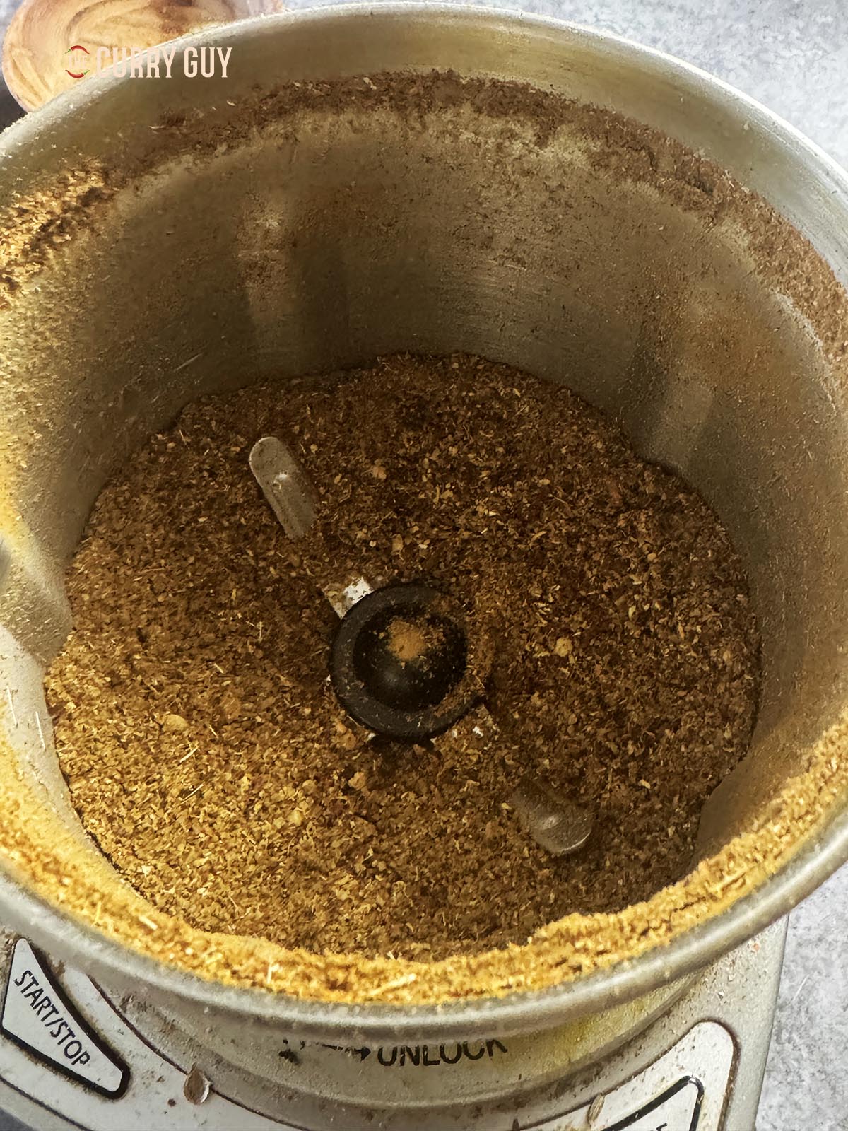 The whole spices after grinding to a powder in a spice grinder. 