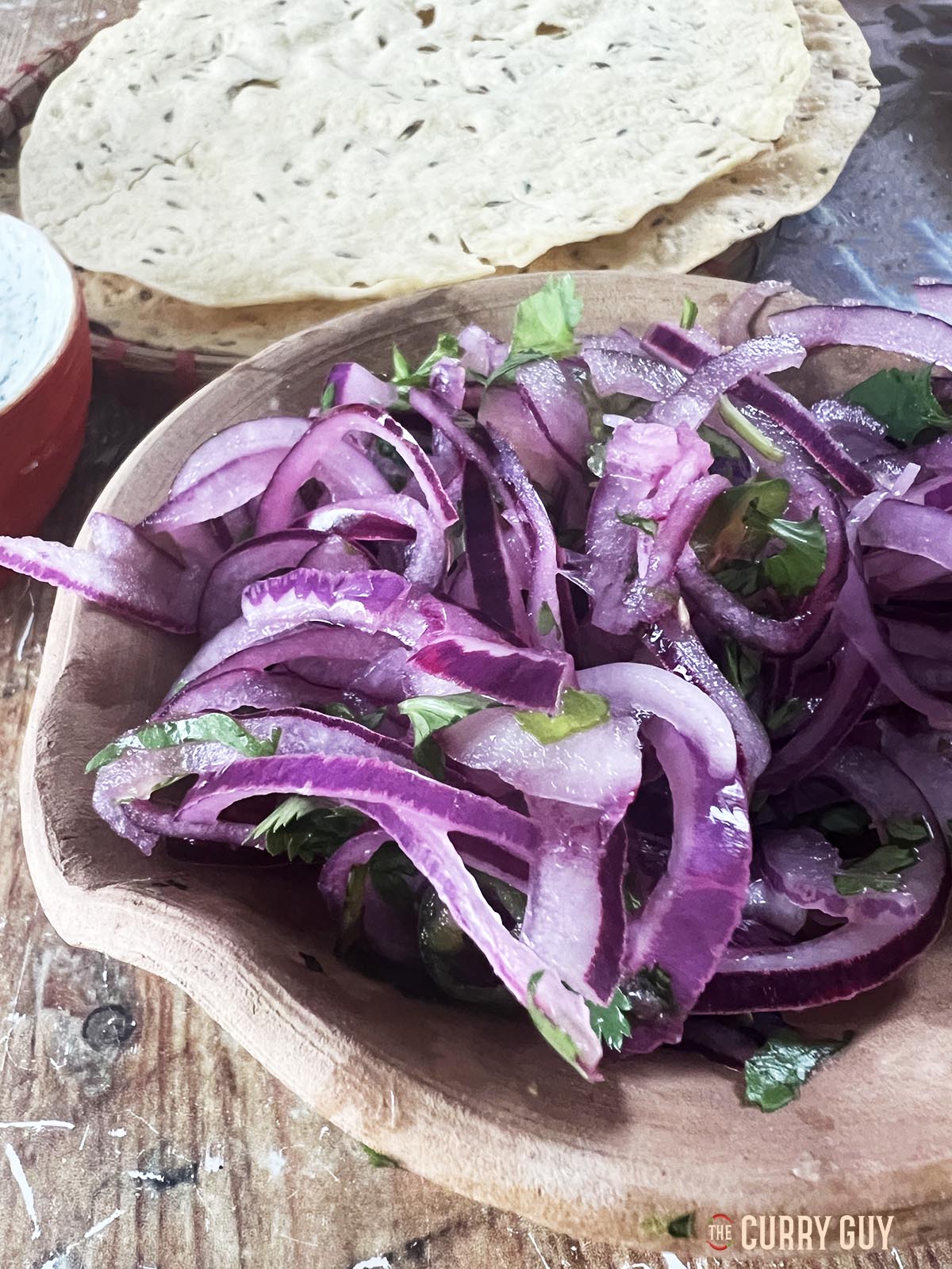 The red onion pickle in a serving bowl.