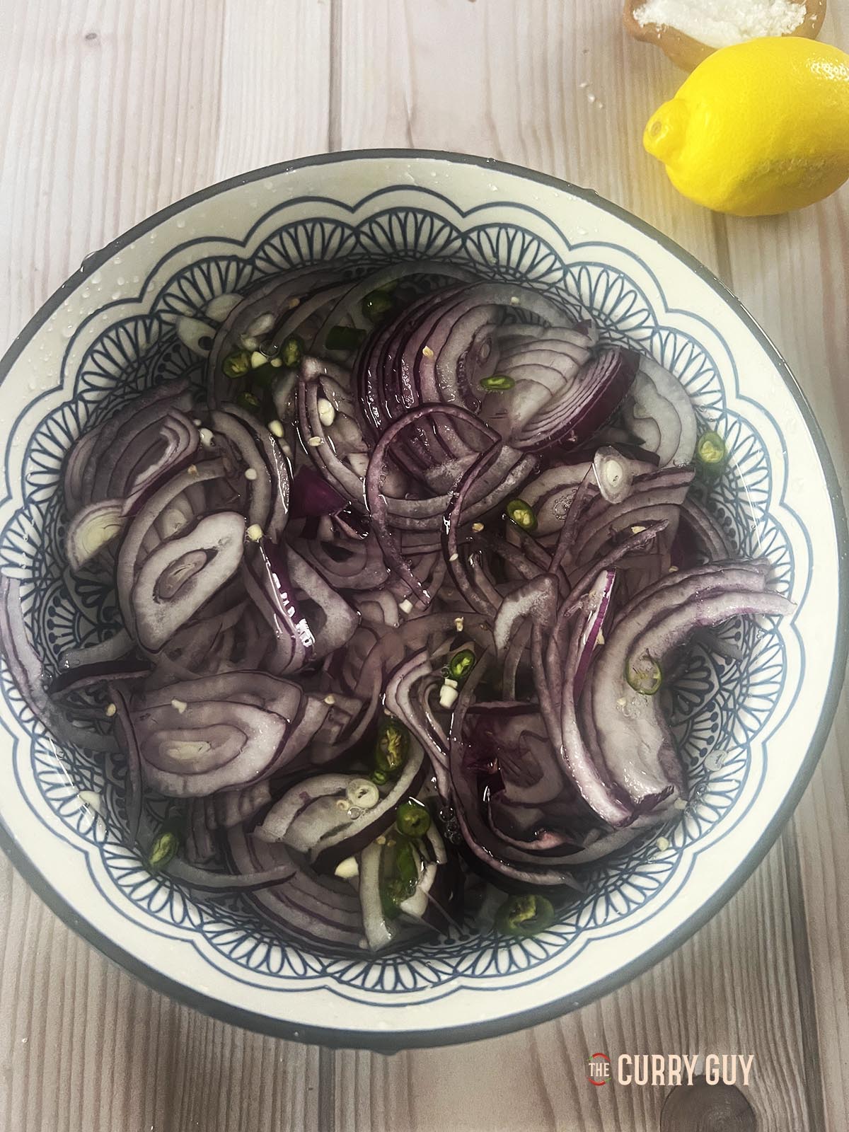 The onions and chillies in a bowl of ice cold water.