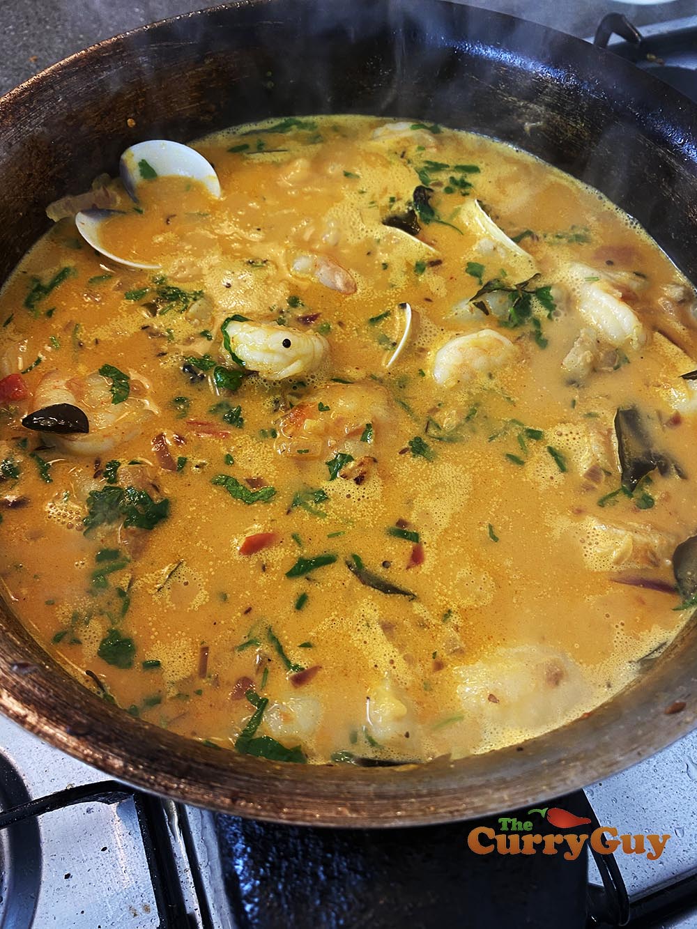 simmering the finished seafood curry