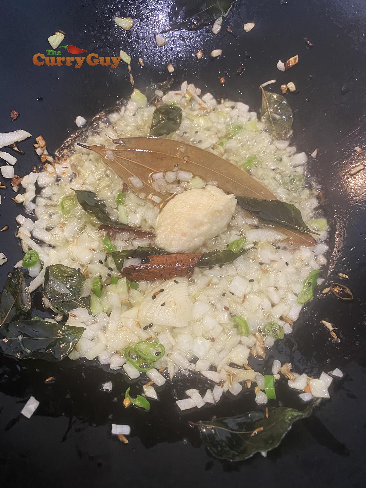 adding garlic and ginger paste to pan