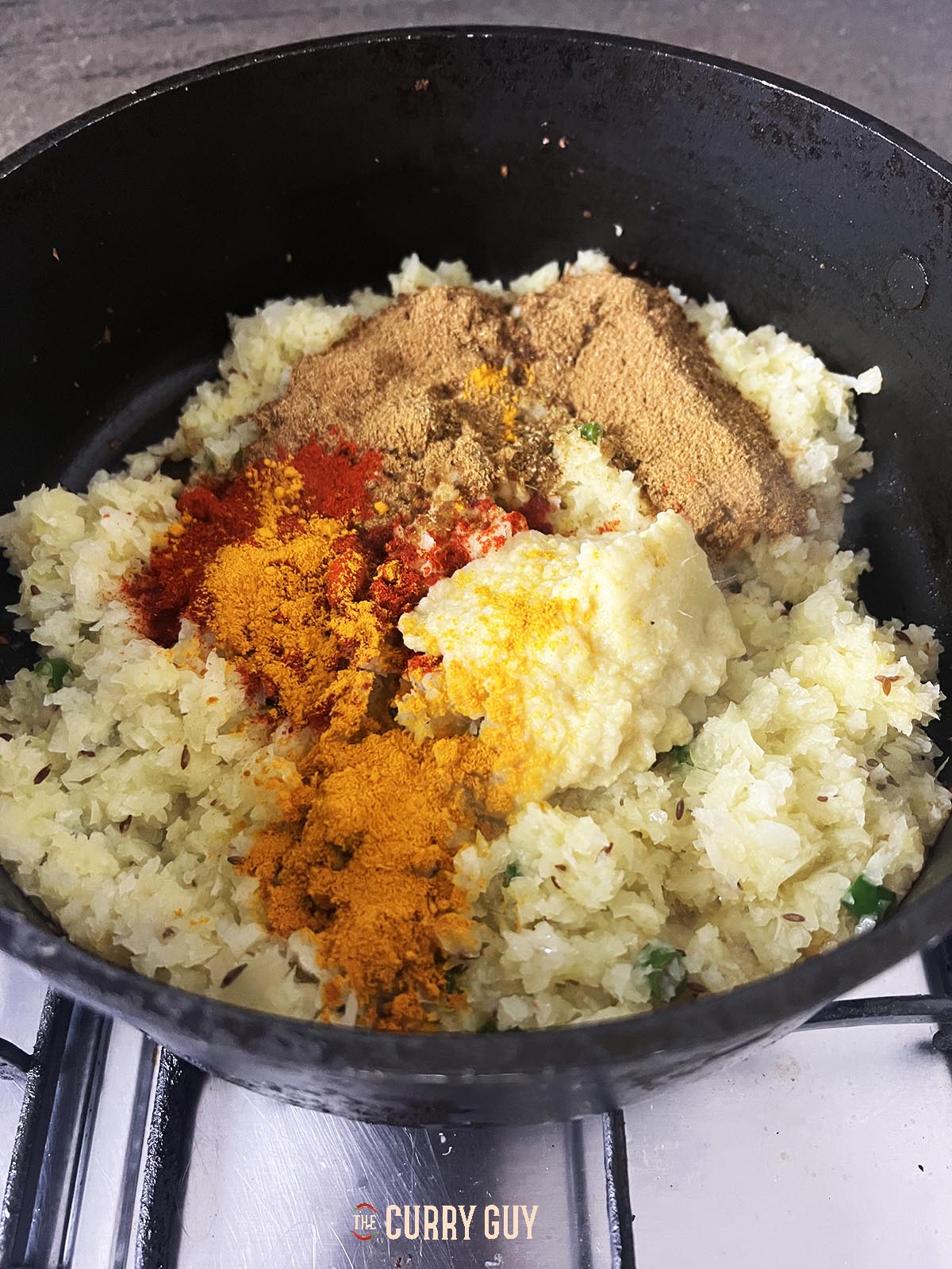 Adding the garlic and ginger along with the ground spices.