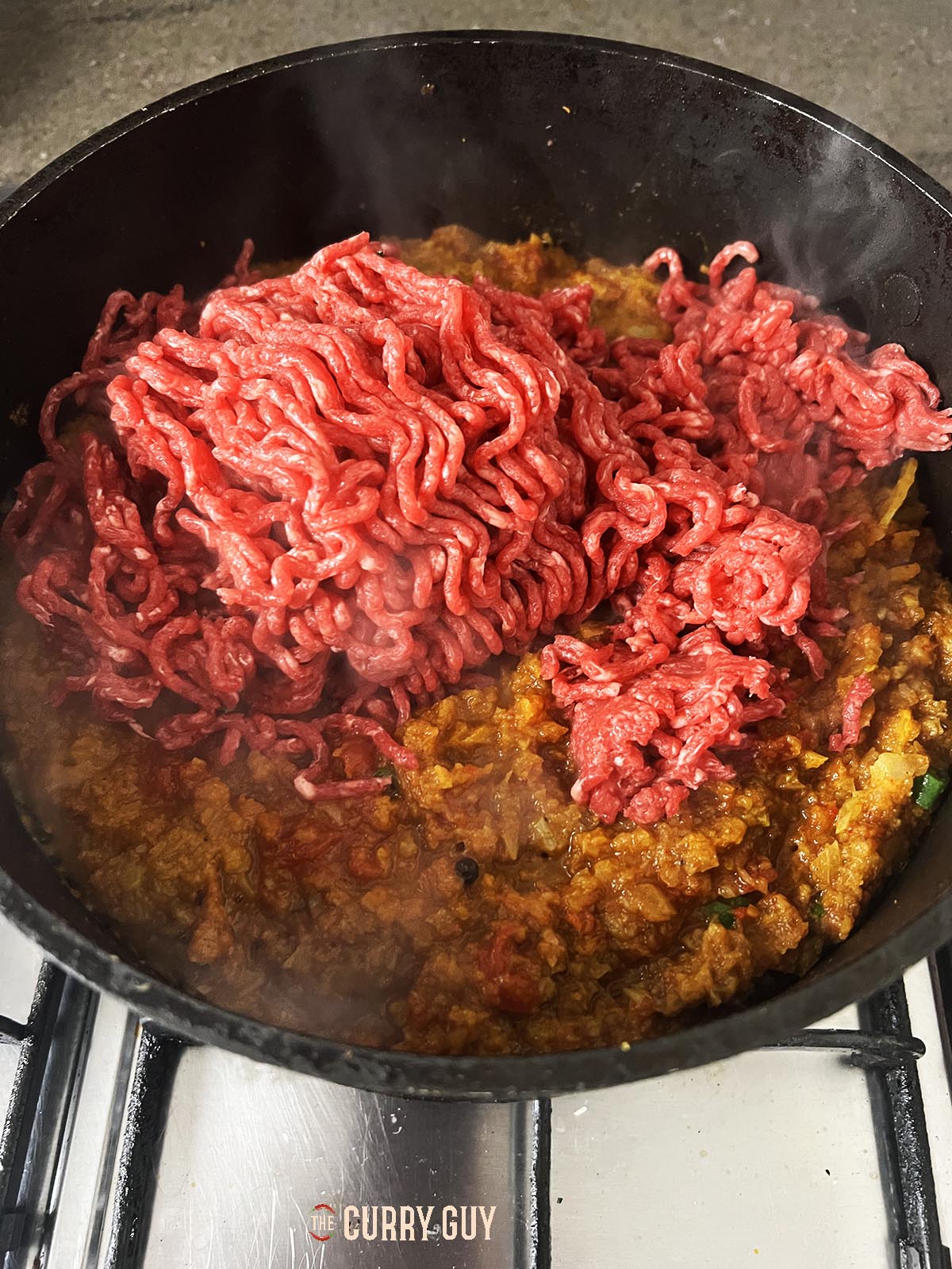 Adding the meat to the pan.