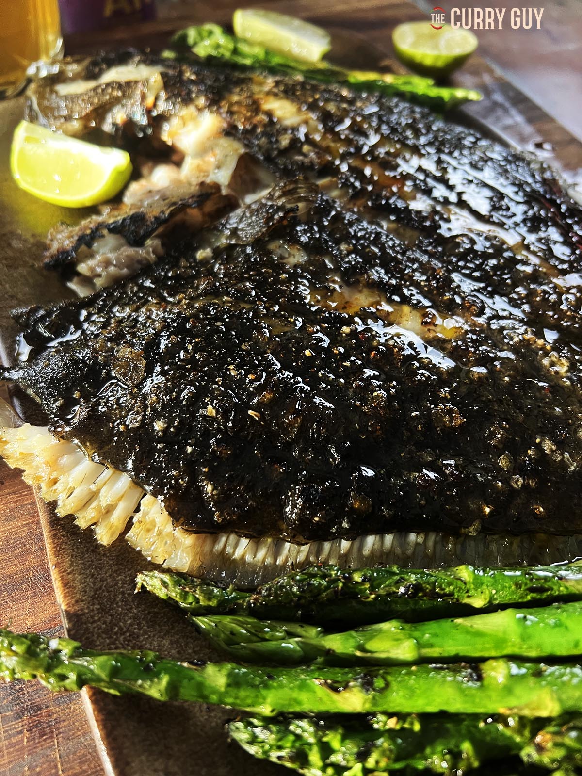 The grilled turbot basted with tandoori masala butter on a countertop.
