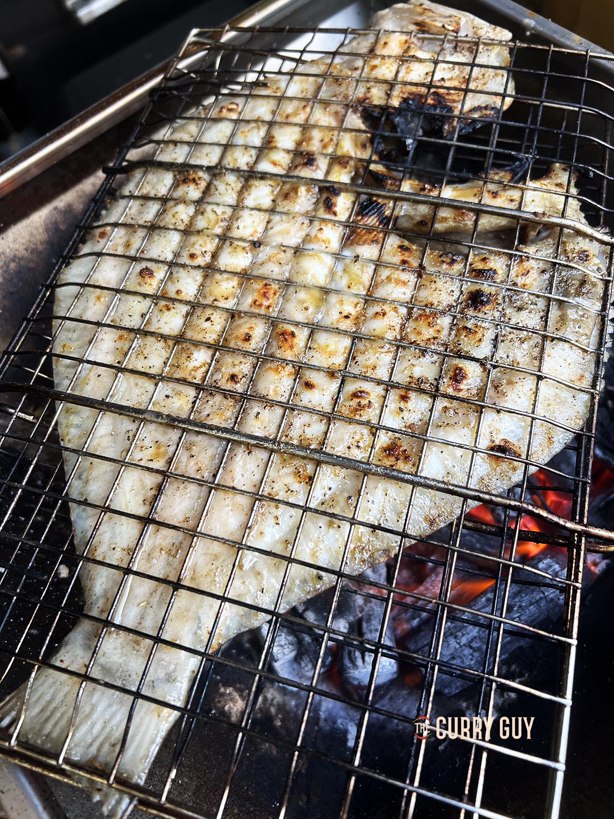 The fish turned over to the underside, showing the charred skin.