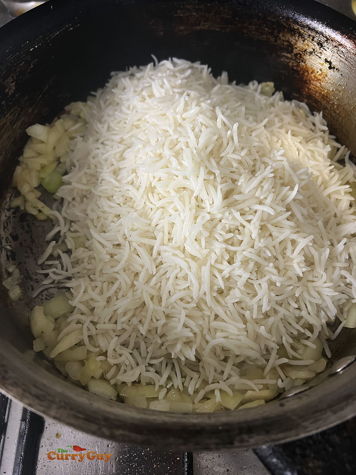 Adding cold Basmati rice to the pan.