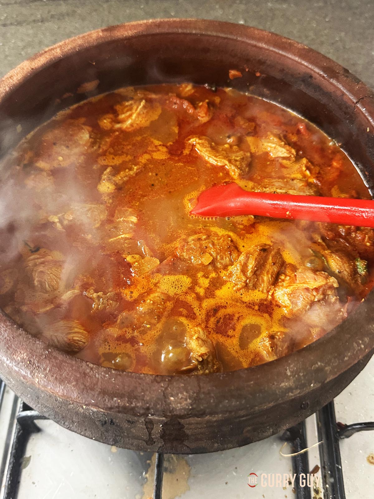 Bringing the curry to a simmer.