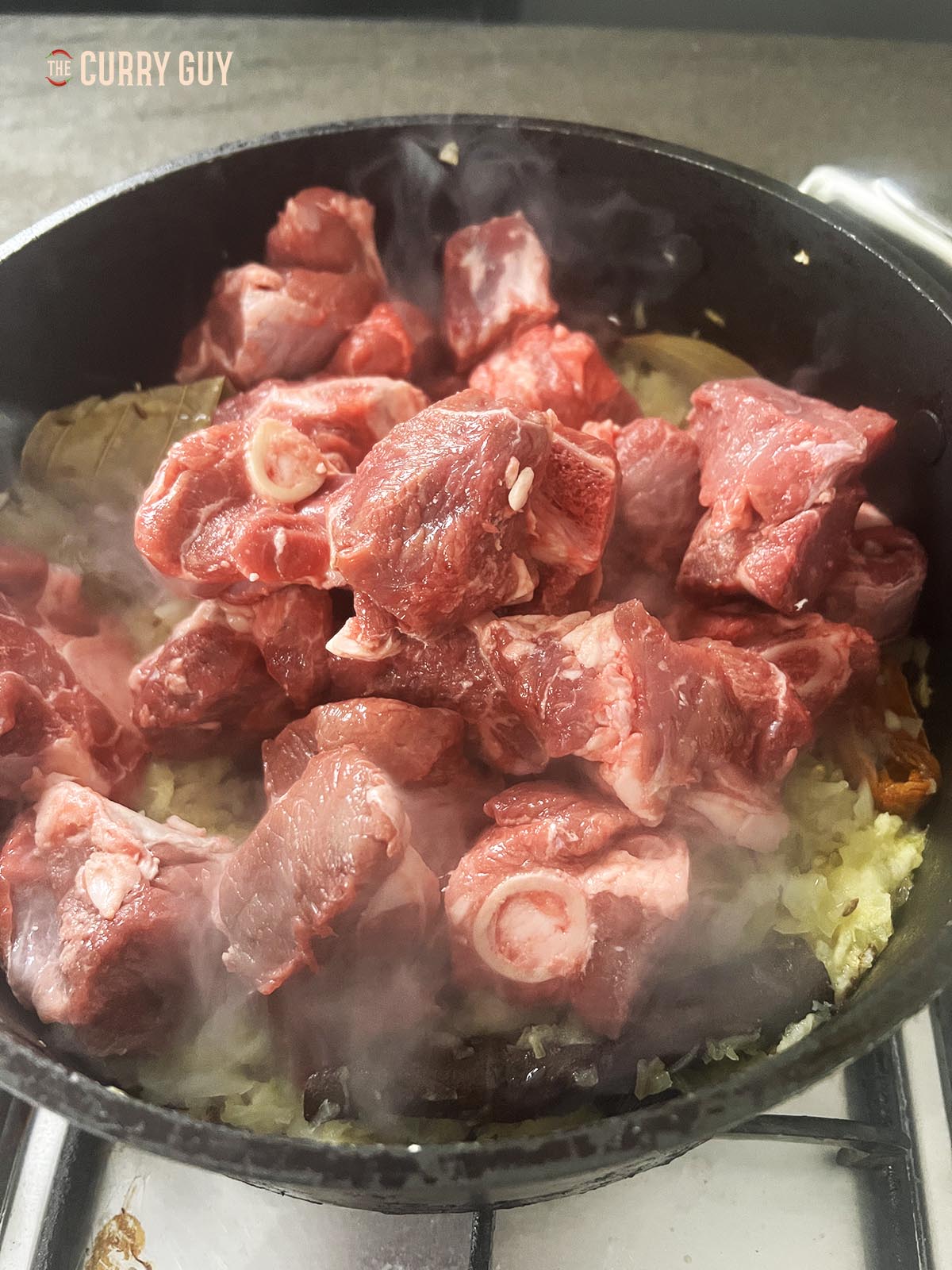 Adding the meat to the pan.