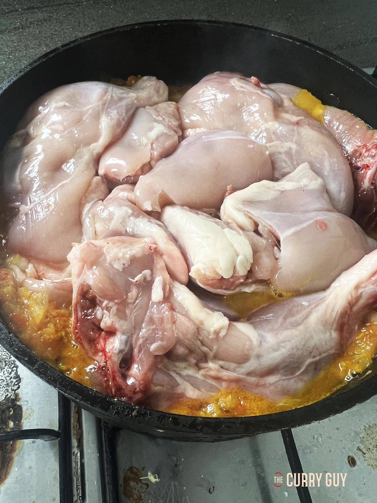 Adding the chicken to the pan.