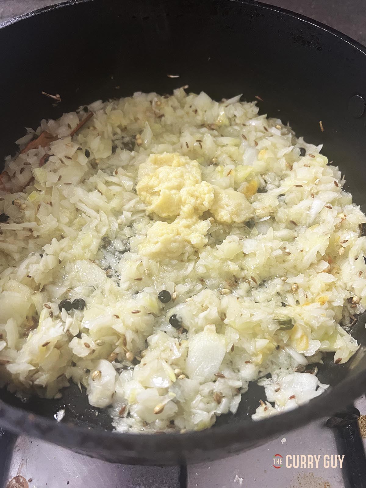 Adding the garlic and ginger paste to the pan.