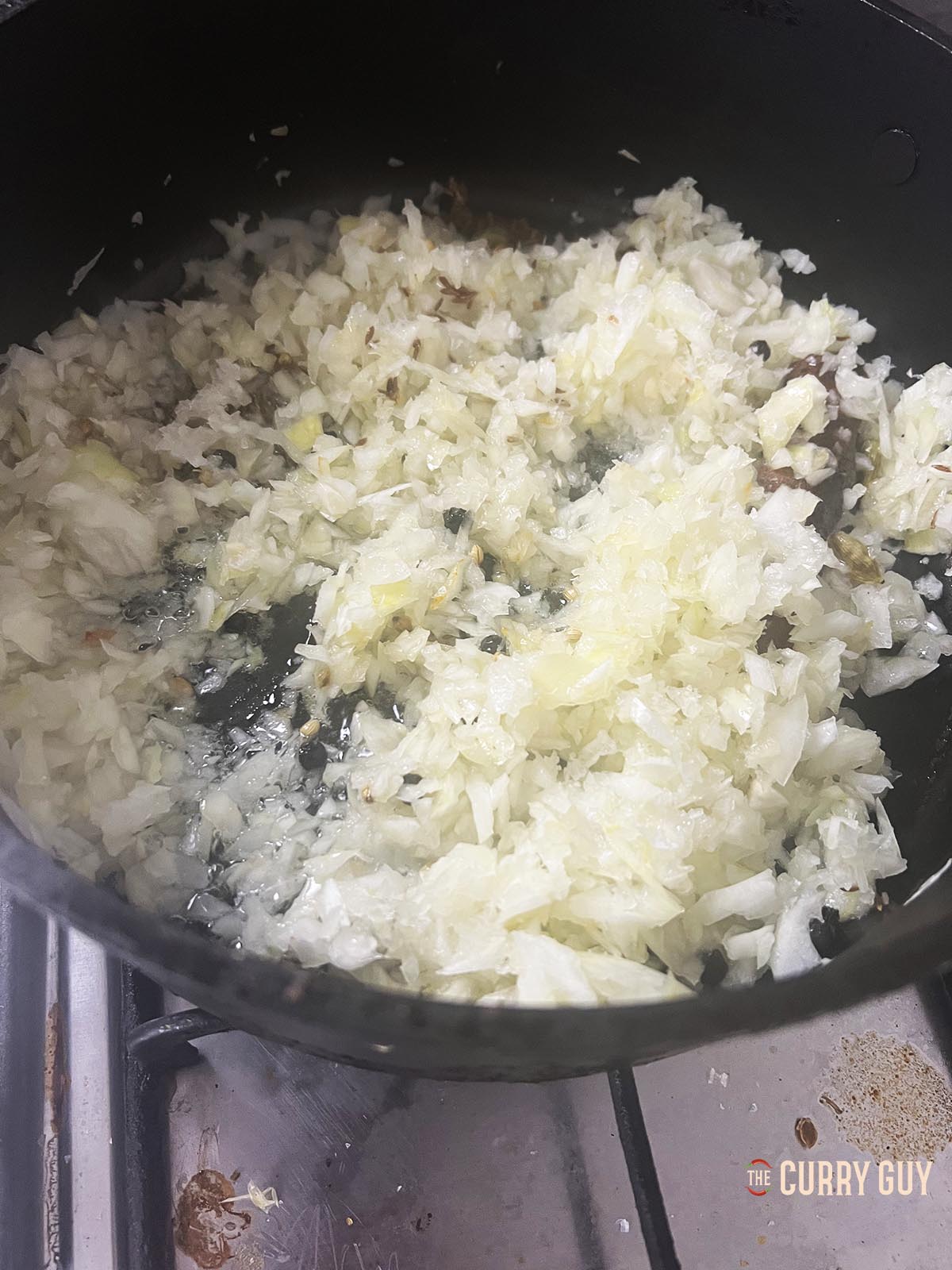 Adding the chopped onions to the pan.