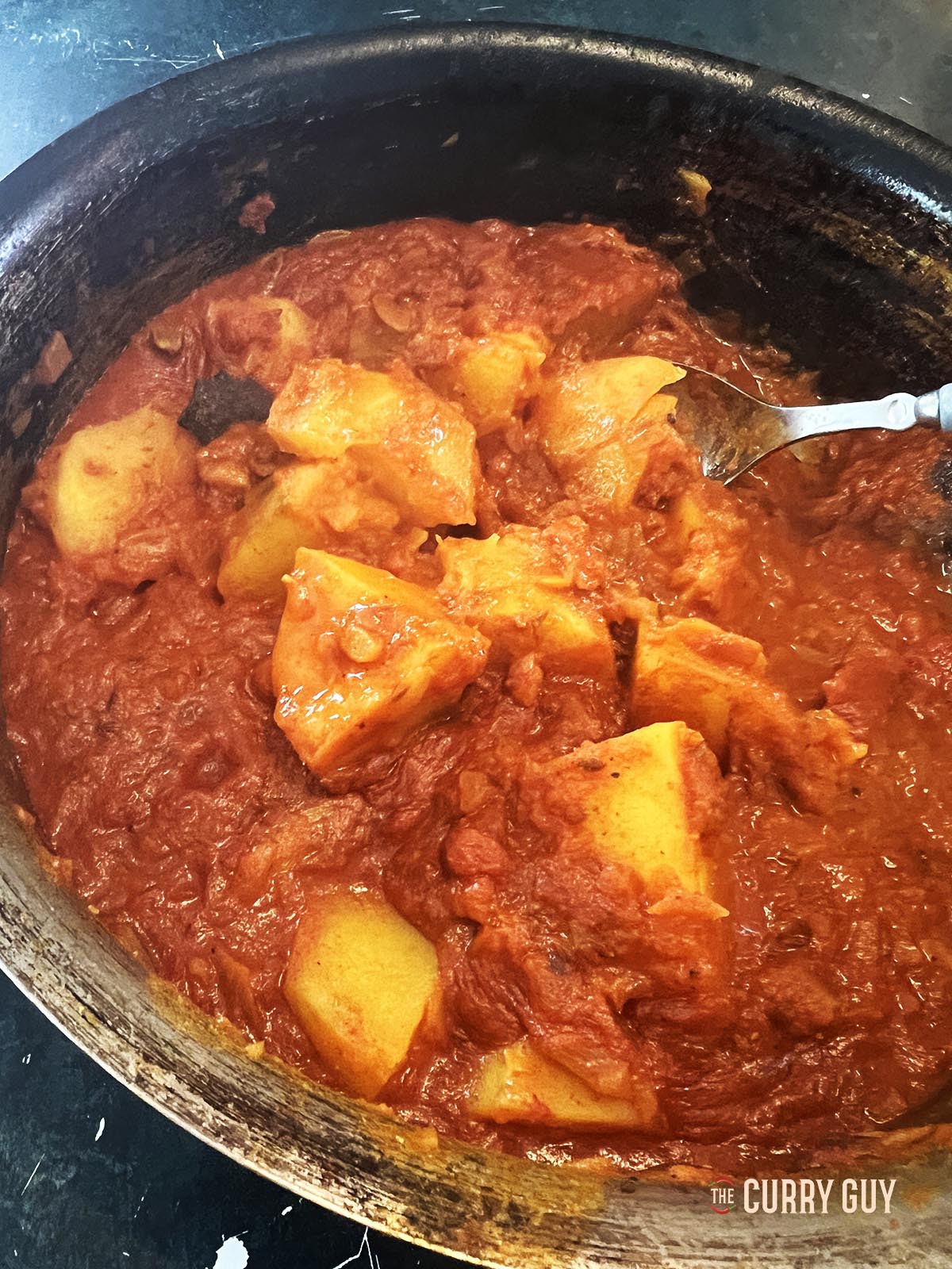 Adding the potatoes and enough water to cover.