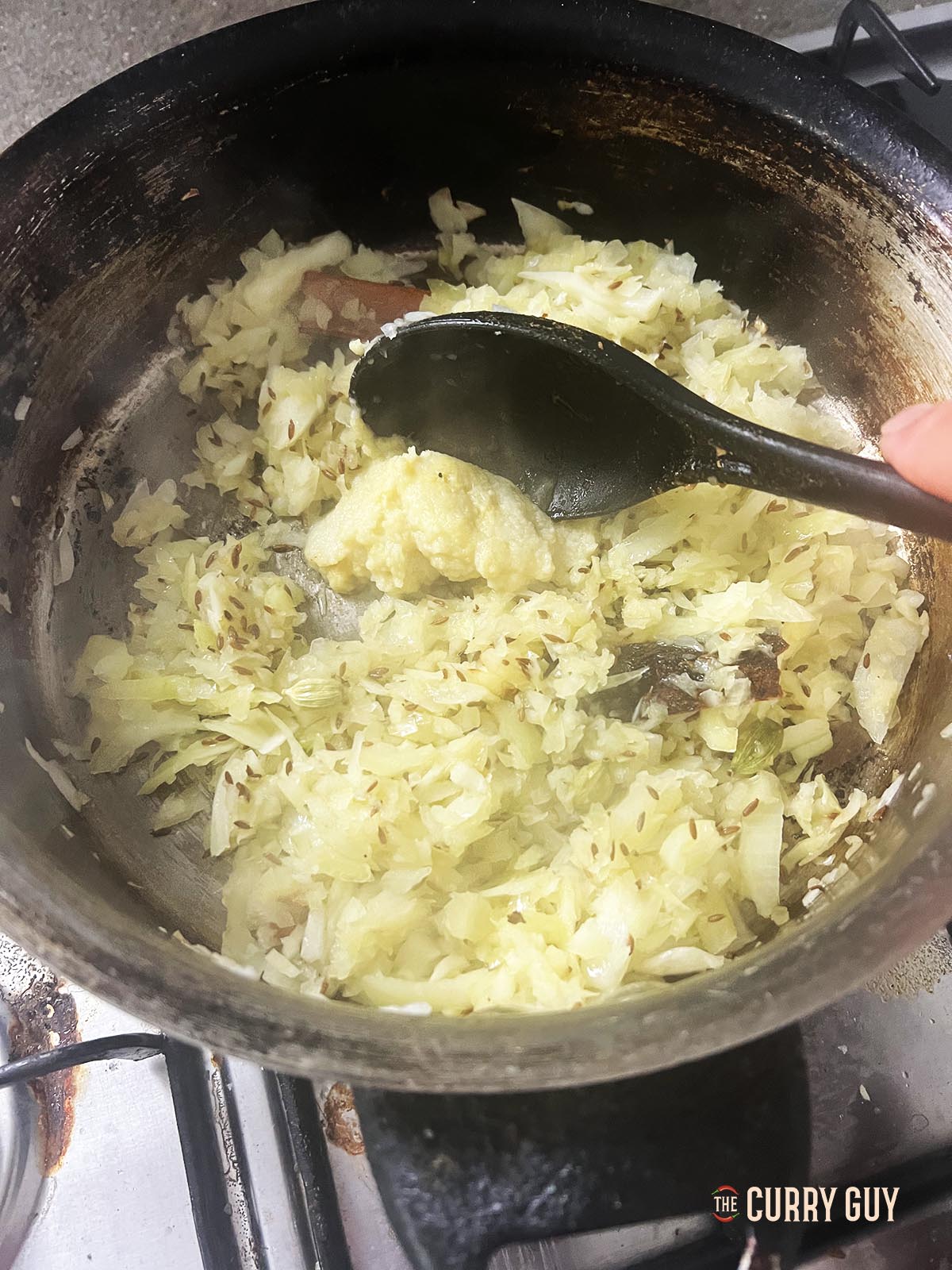 Adding the chopped onions to the pan.