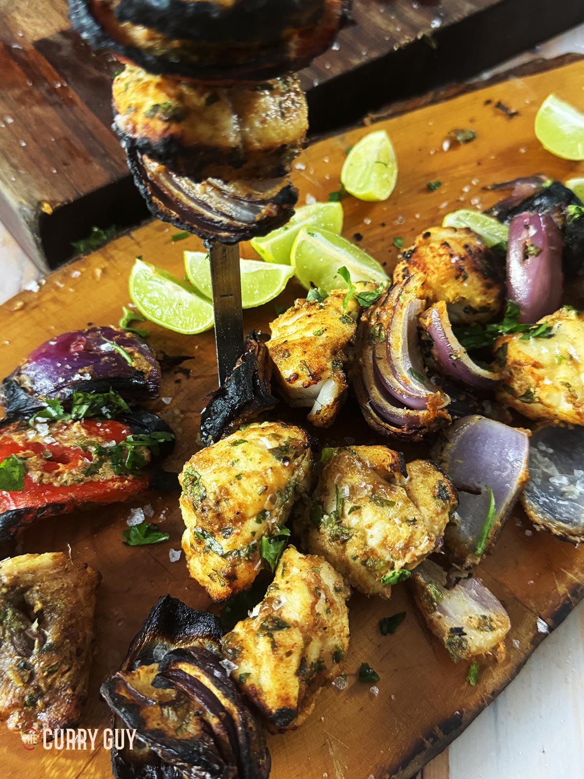 The grilled monkfish and vegetables on a serving platter. 