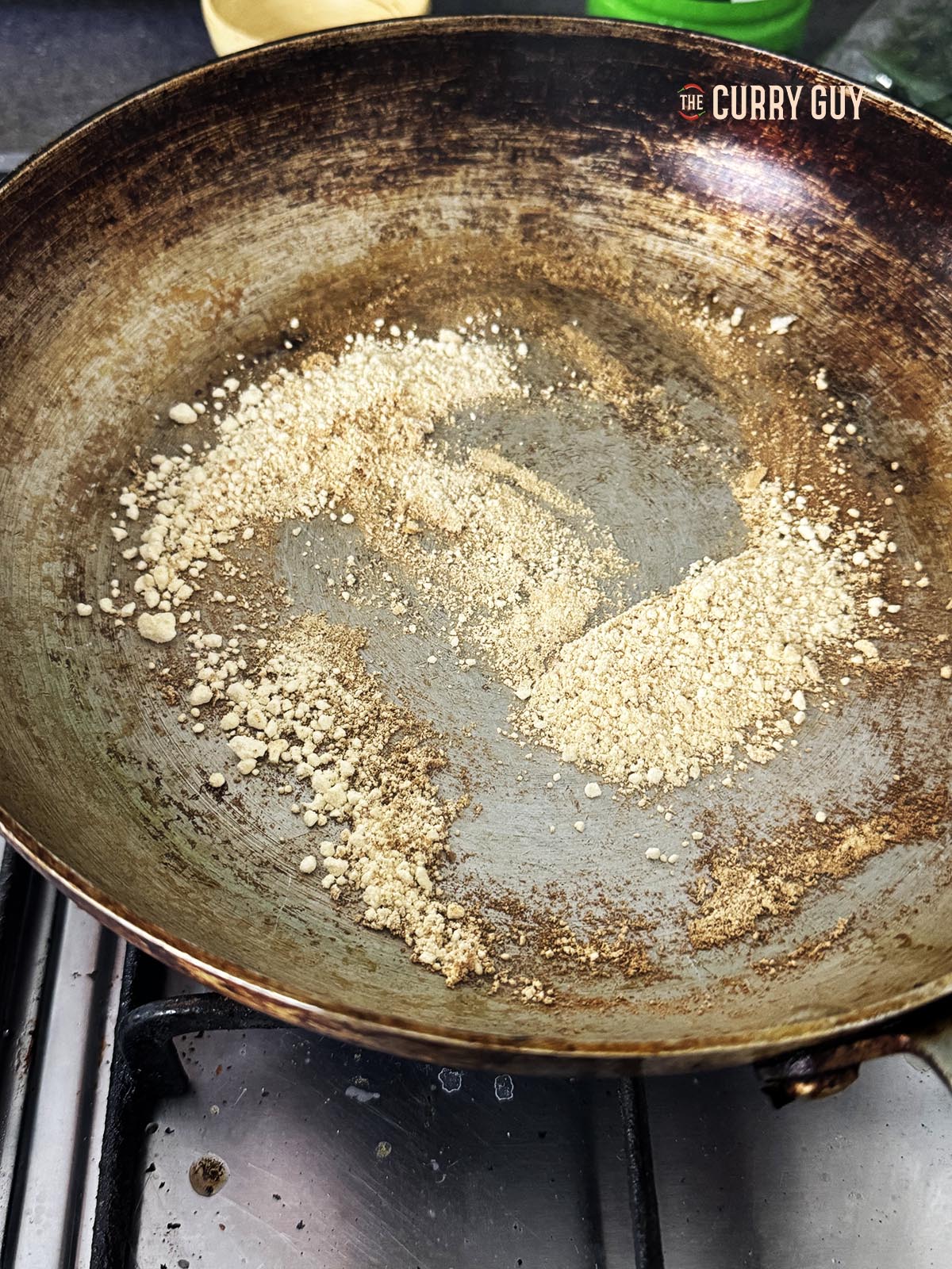Toasting the gram flour in a pan.