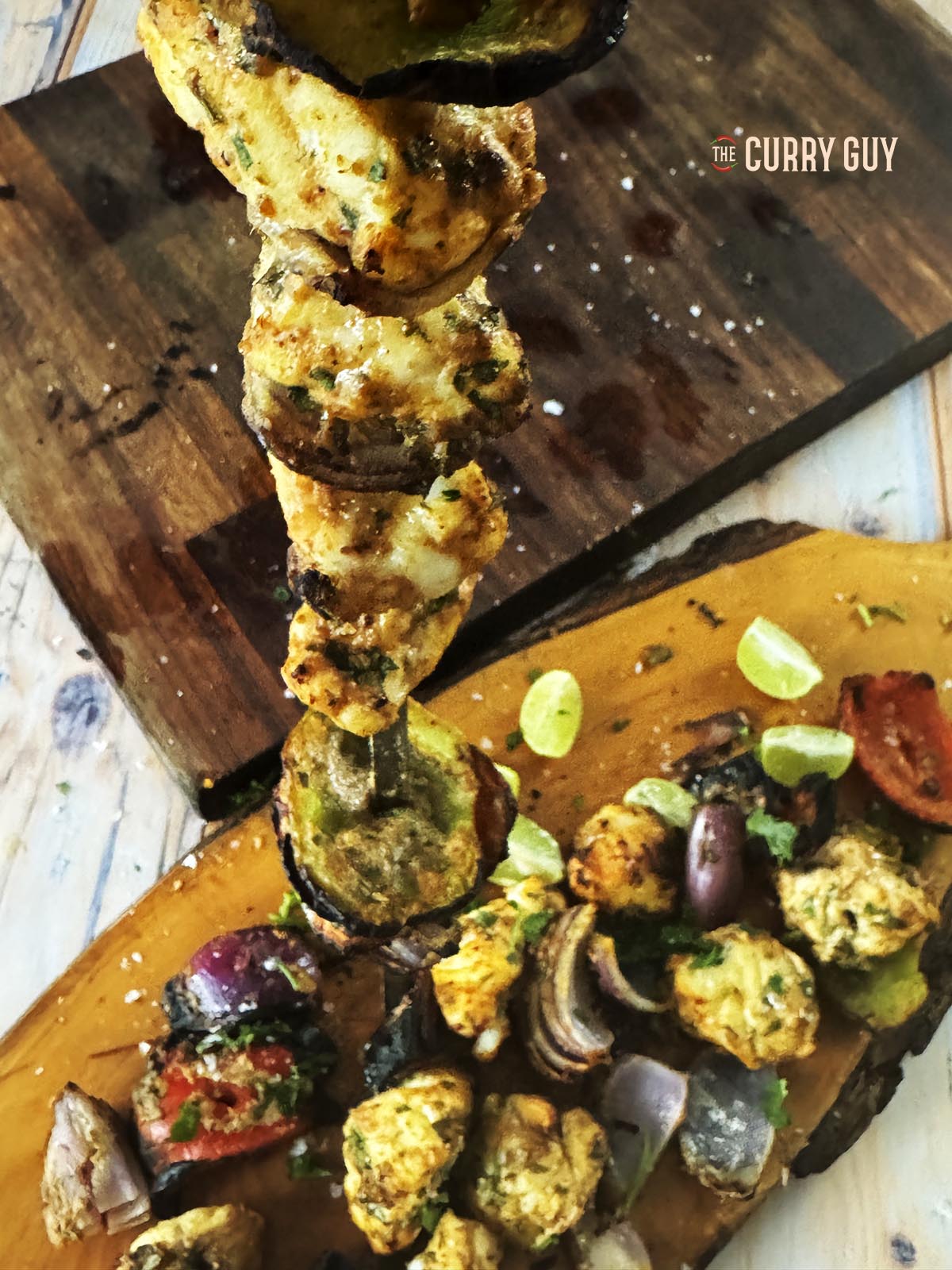 Removing the monkfish and vegetables from a skewer.