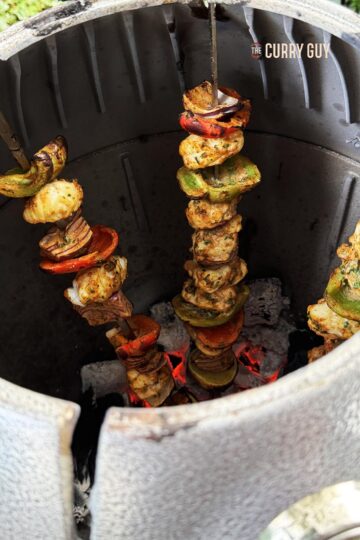 Grilled monkfish cooking in a tandoor oven.
