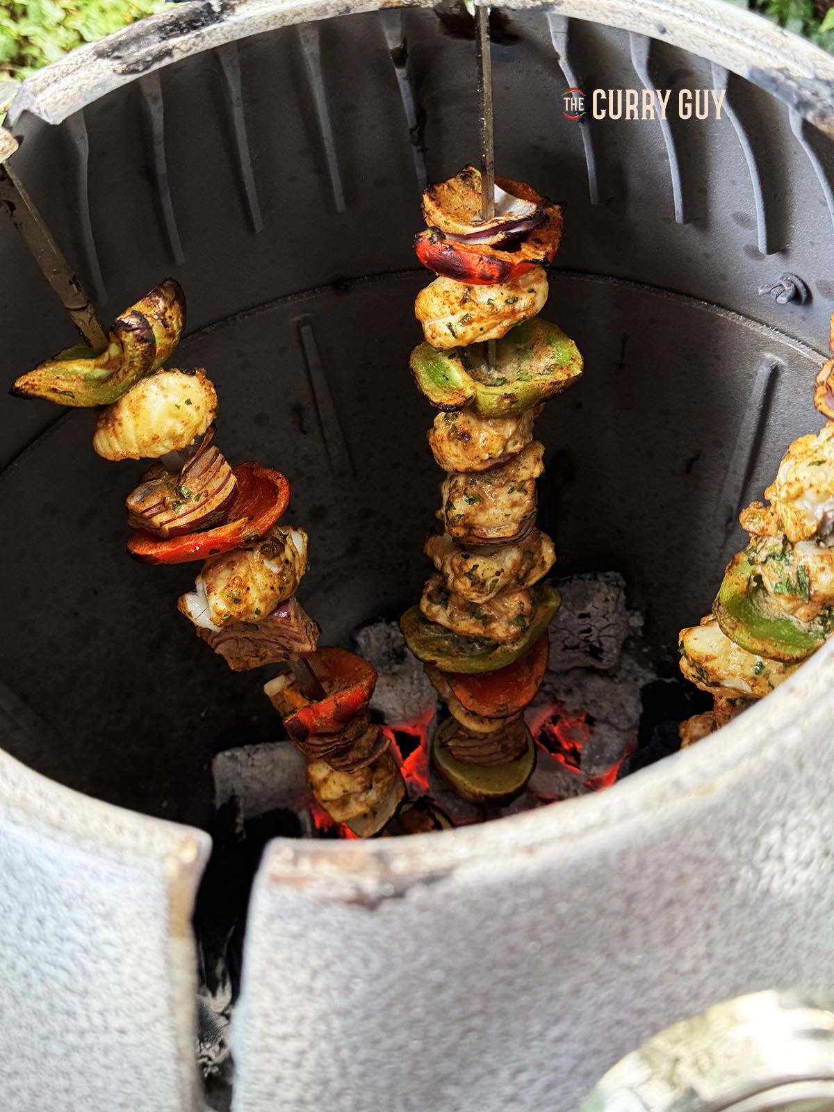 Grilled monkfish cooking in a tandoor oven.