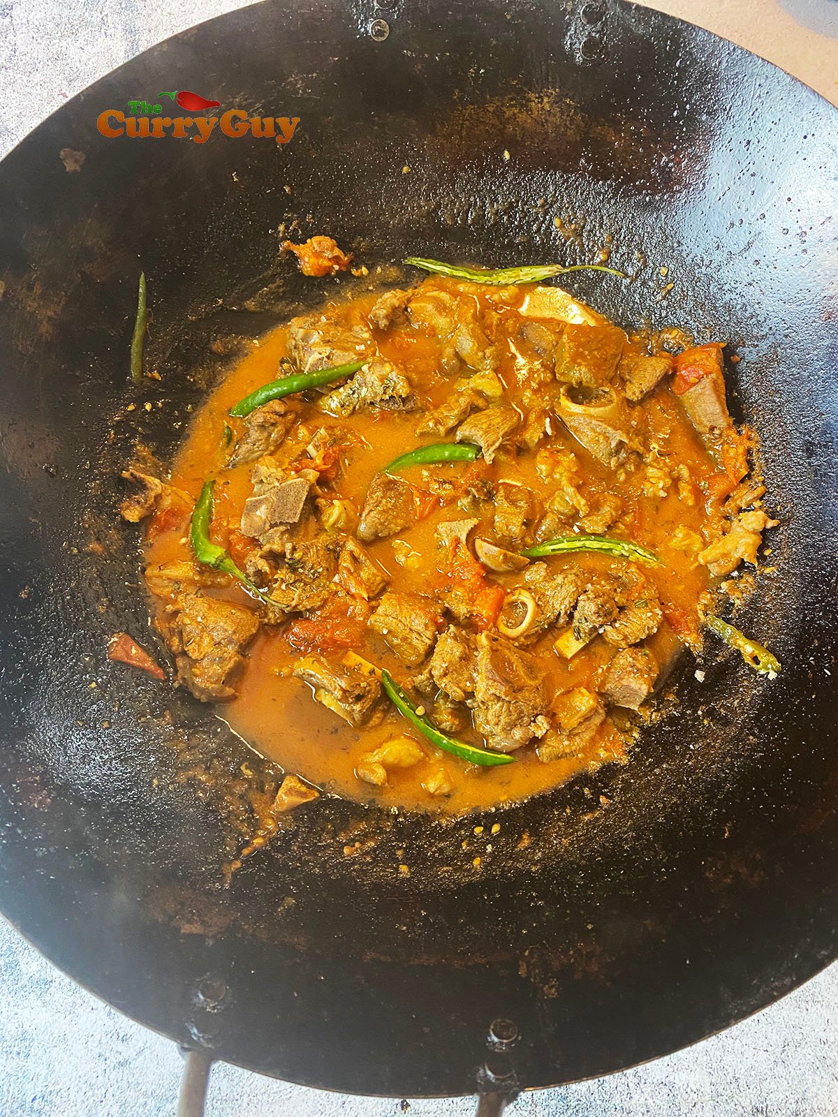 Adding chillies to karahi