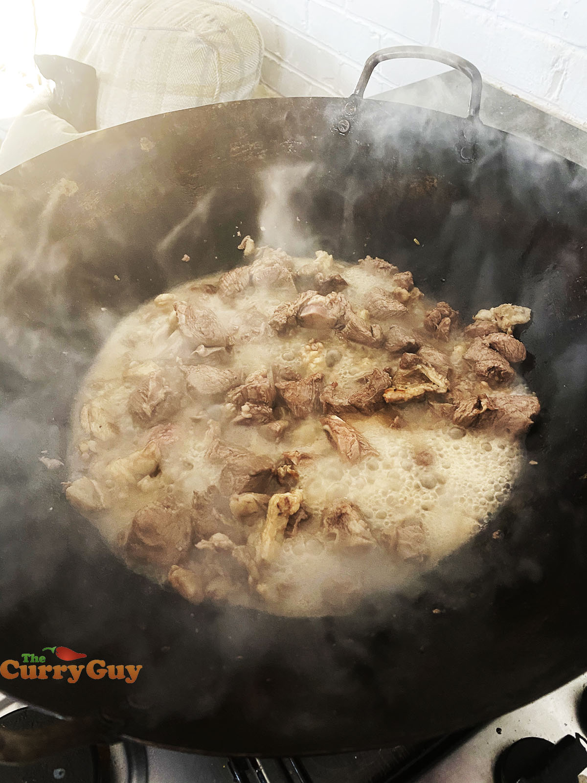 Adding garlic water to pan