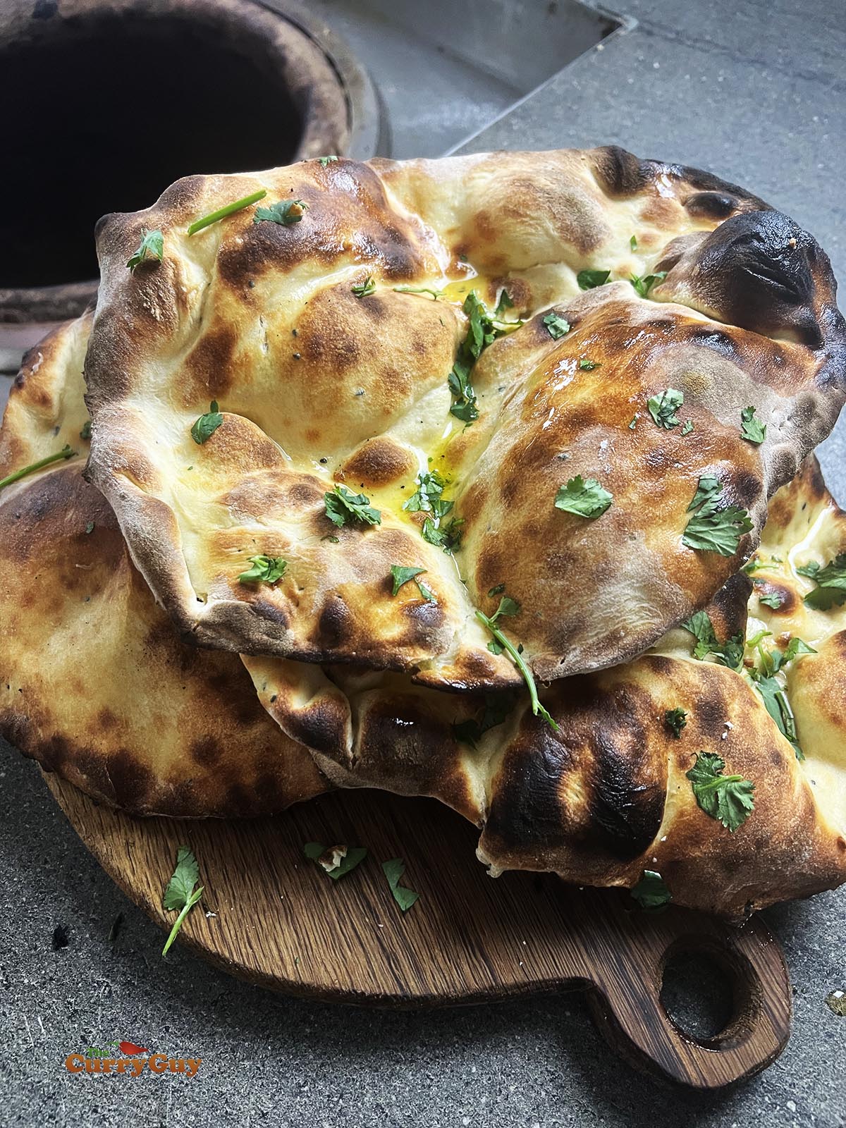 Tandoori naans fresh out of the tandoor oven