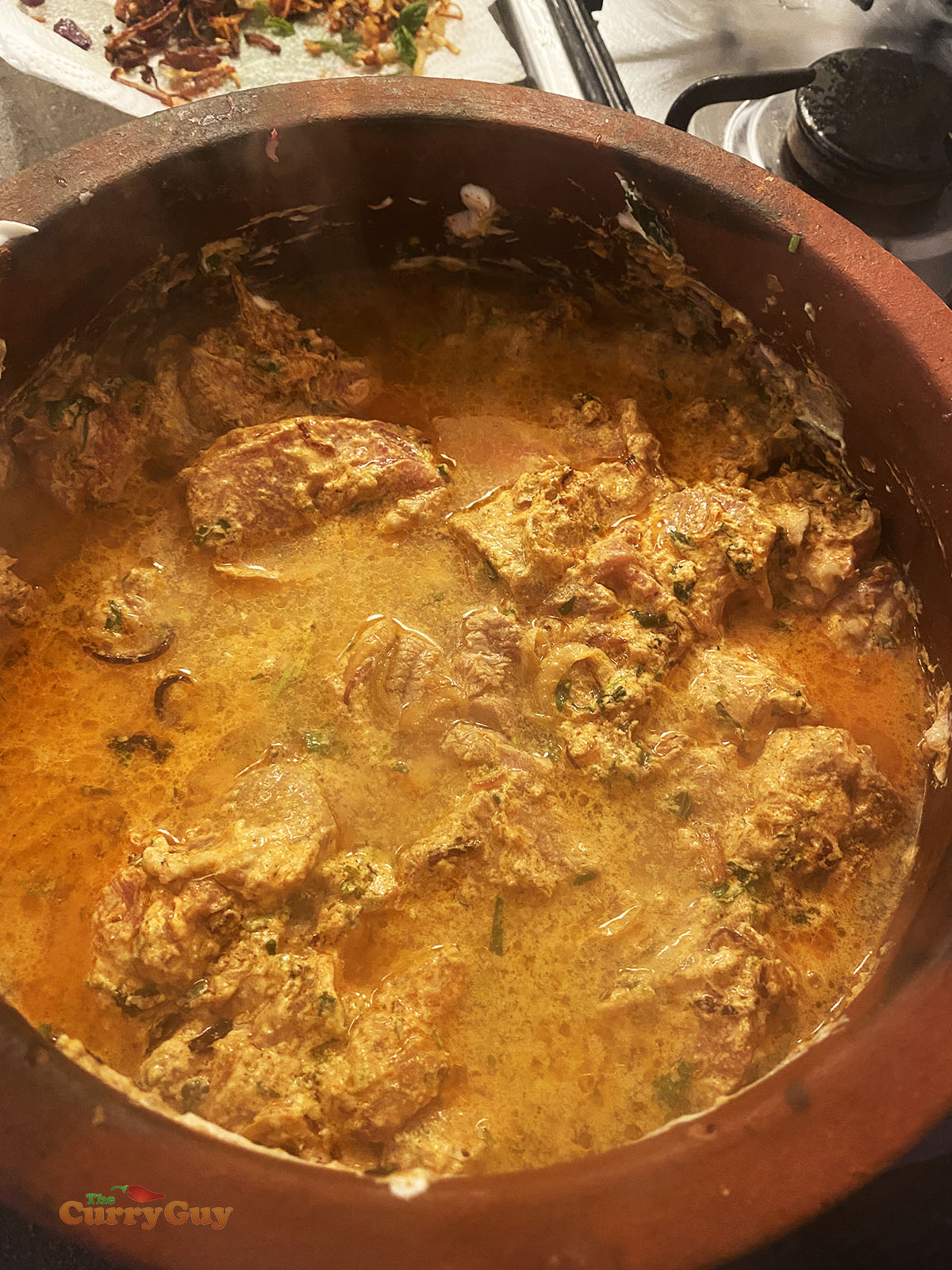 Adding water to the biryani pot.