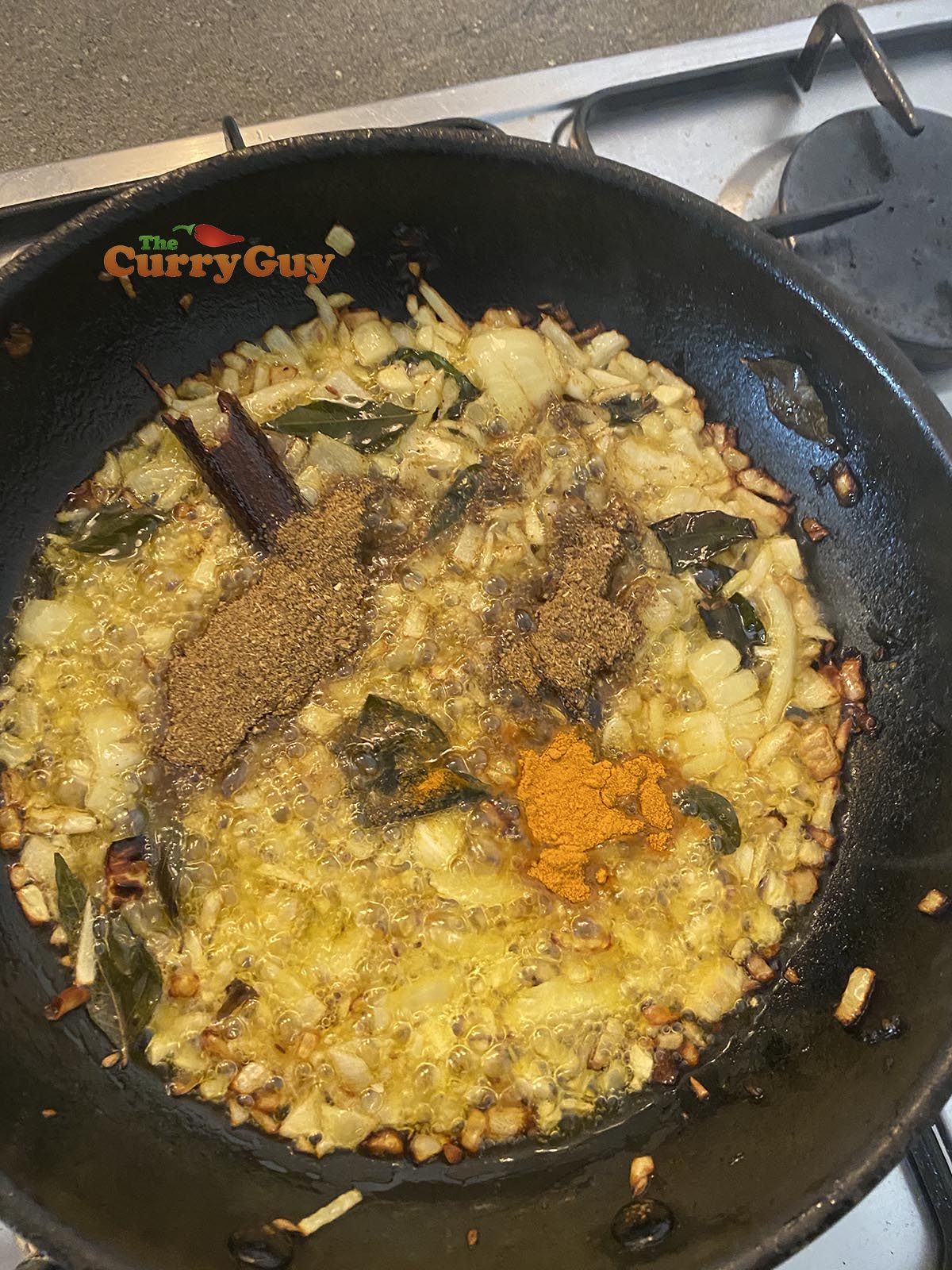 Adding ground spices to the pan